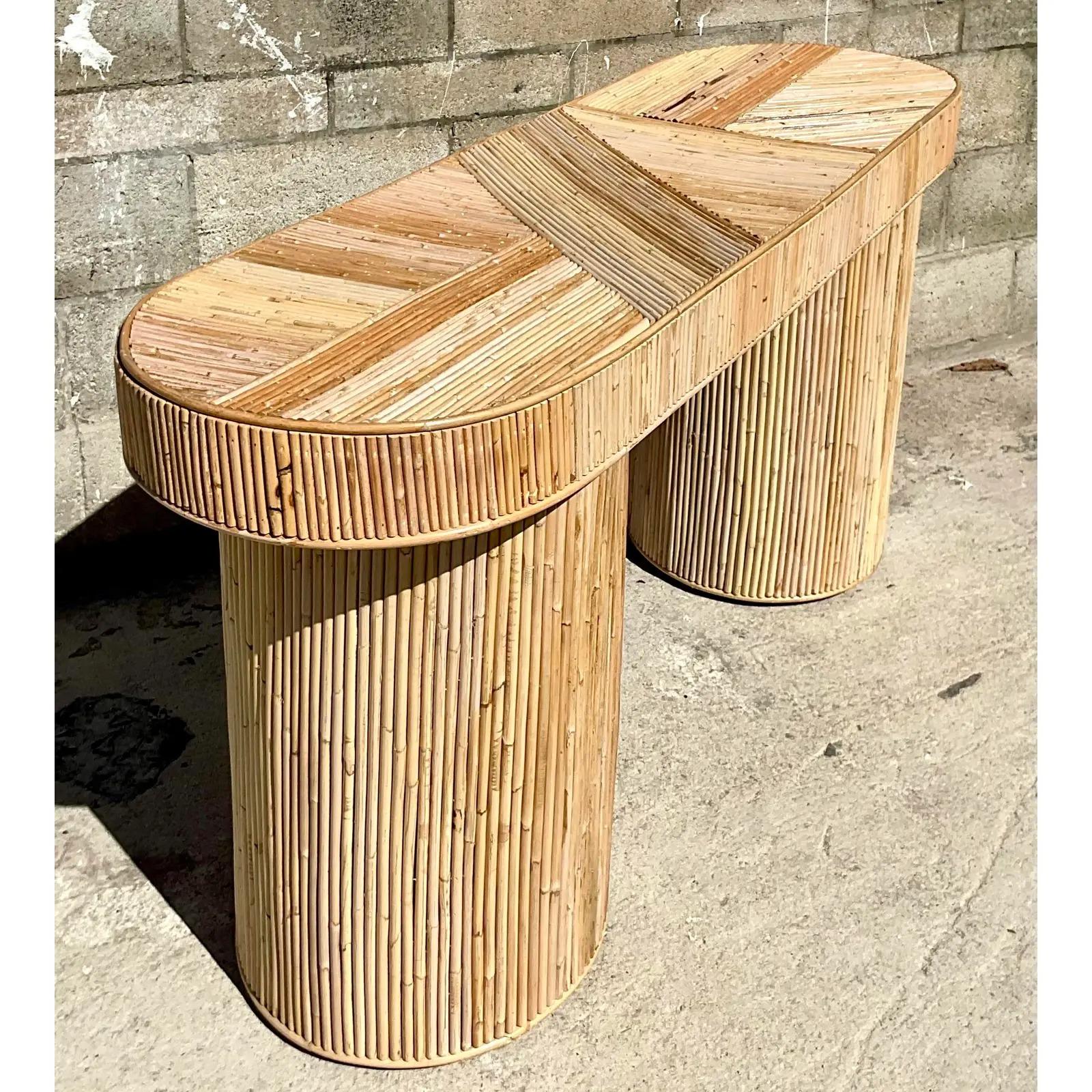 Spectacular vintage Coastal console table. Beautiful pencil reed construction in a chic oval design. A multi directional design gives it a Contemporary and Coastal look. Acquired from a Palm Beach estate.
