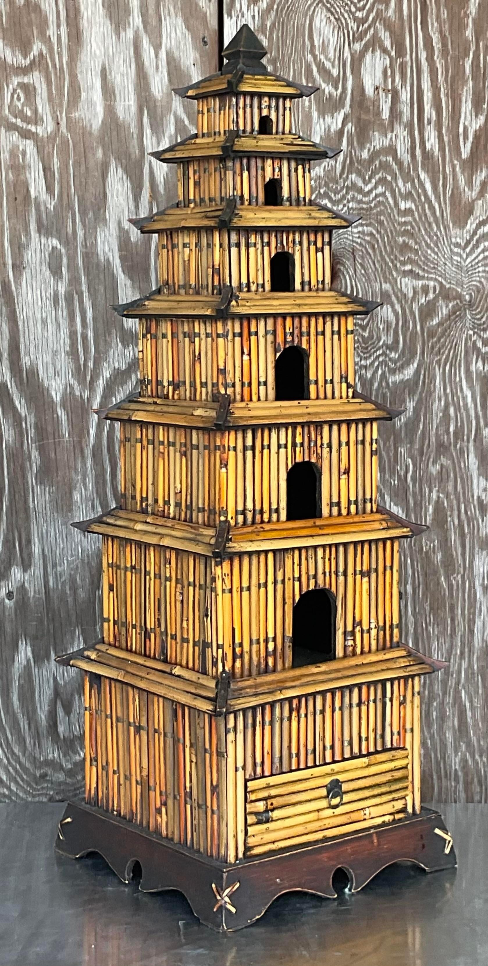 A fabulous vintage Coastal tall pagoda. A chic pencil reed construction with a tiny drawer for you to keep your secret treasures. Monumental in size and drama. Acquired from a Palm Beach estate.