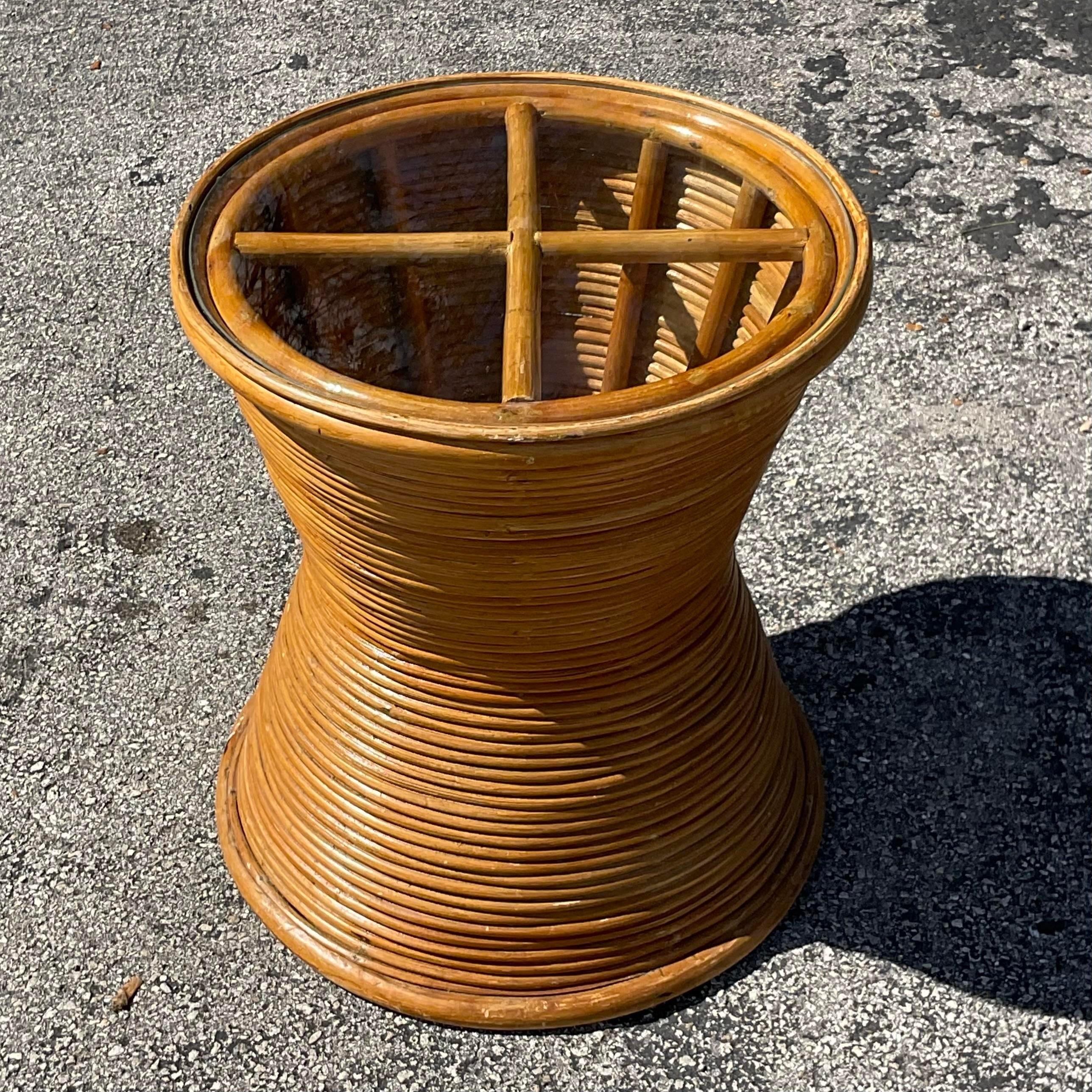 A fabulous vintage Coastal side table. A chic coiled pencil reed with an inset glass top. Perfect as a side table or pedestal for your favorite sculpture or even a plant stand. You decide! Acquired from a Palm Beach estate. 