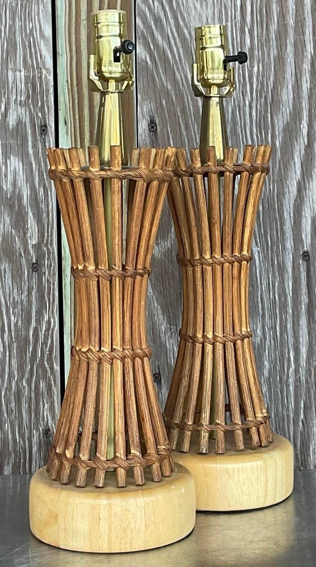Bring coastal elegance to your home with this pair of vintage coastal pencil reed table lamps. Combining coastal vibes with American craftsmanship, these lamps feature intricate reed designs, adding natural warmth and charm to any space.