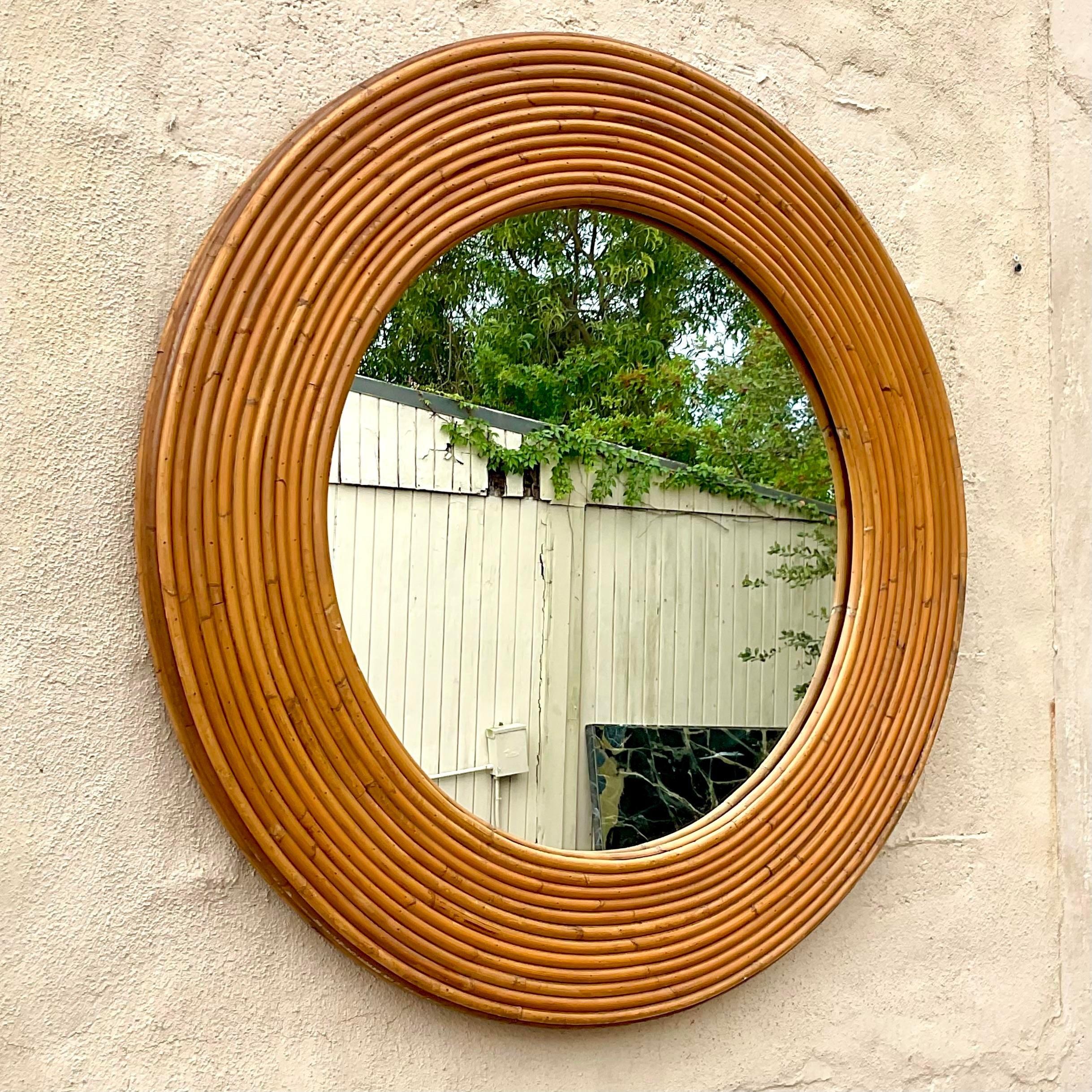 A fantastic vintage Coastal wall mirror. A chic pencil reed construction in a classic red shape. Acquired from a Palm Beach estate. 