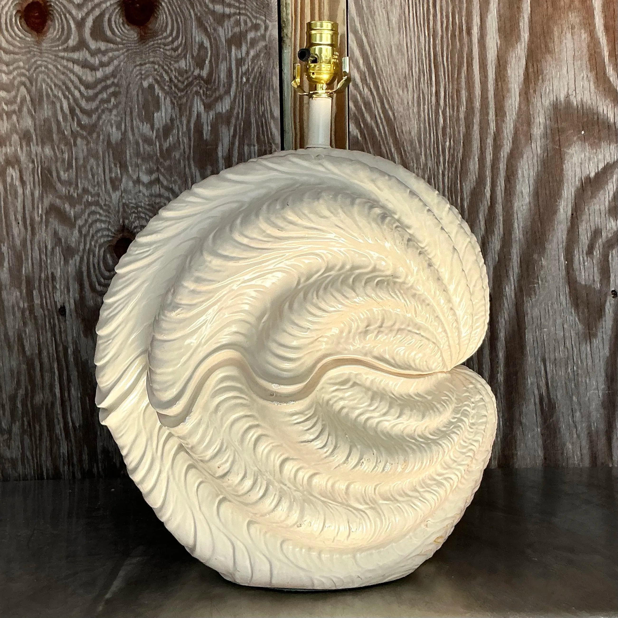 This Vintage Coastal Plaster Clamshell Lamp - A Pair brings a perfect blend of coastal charm and timeless design. Crafted from plaster, these lamps feature an elegant clamshell motif that evokes the serene beauty of the sea. The textured plaster
