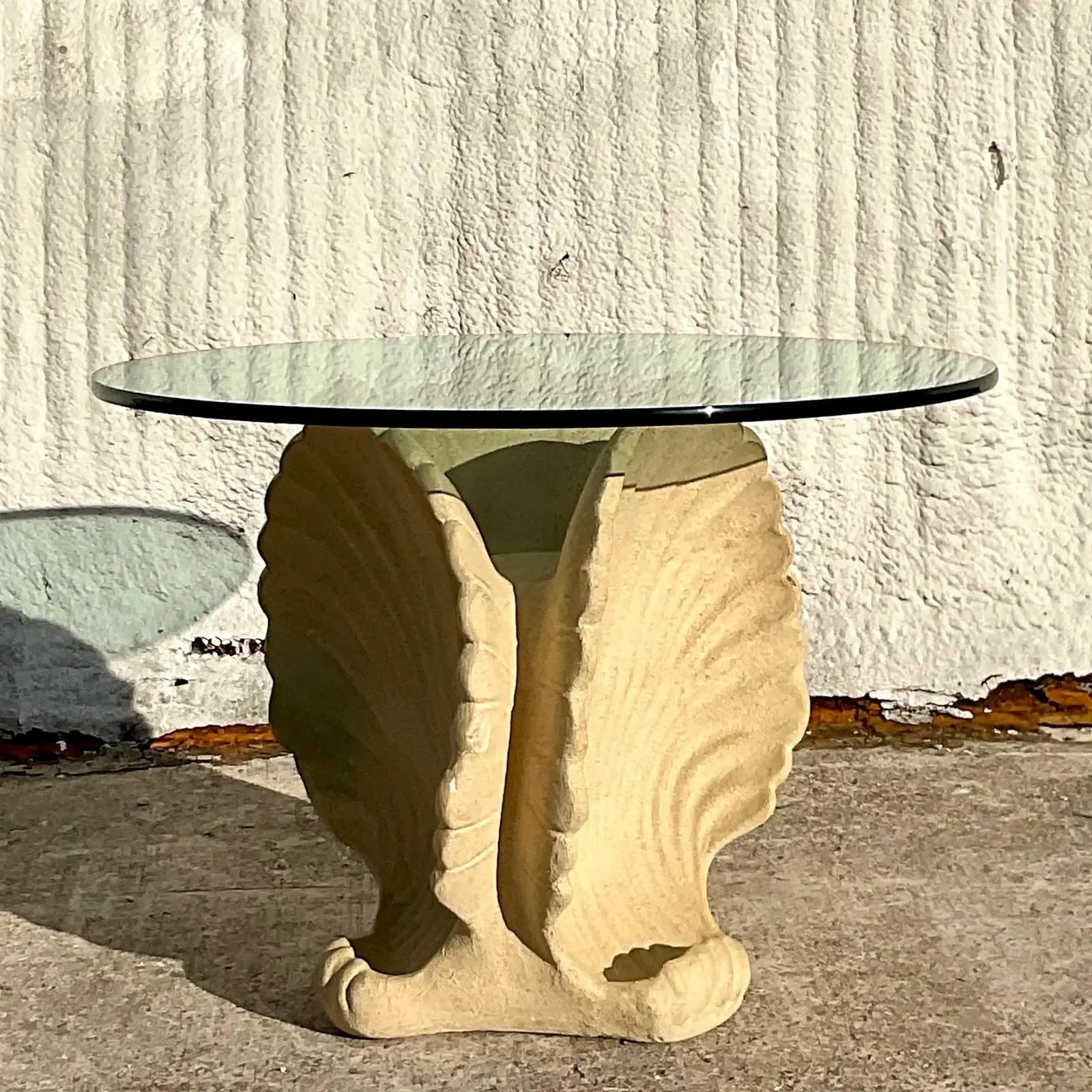 A fabulous vintage Coastal Plaster dining table. Beautiful triple clamshell design with a thick glass top. Perfect as a small dining table or a gorgeous entry hall table. You decide! Acquired from a Palm Beach estate.