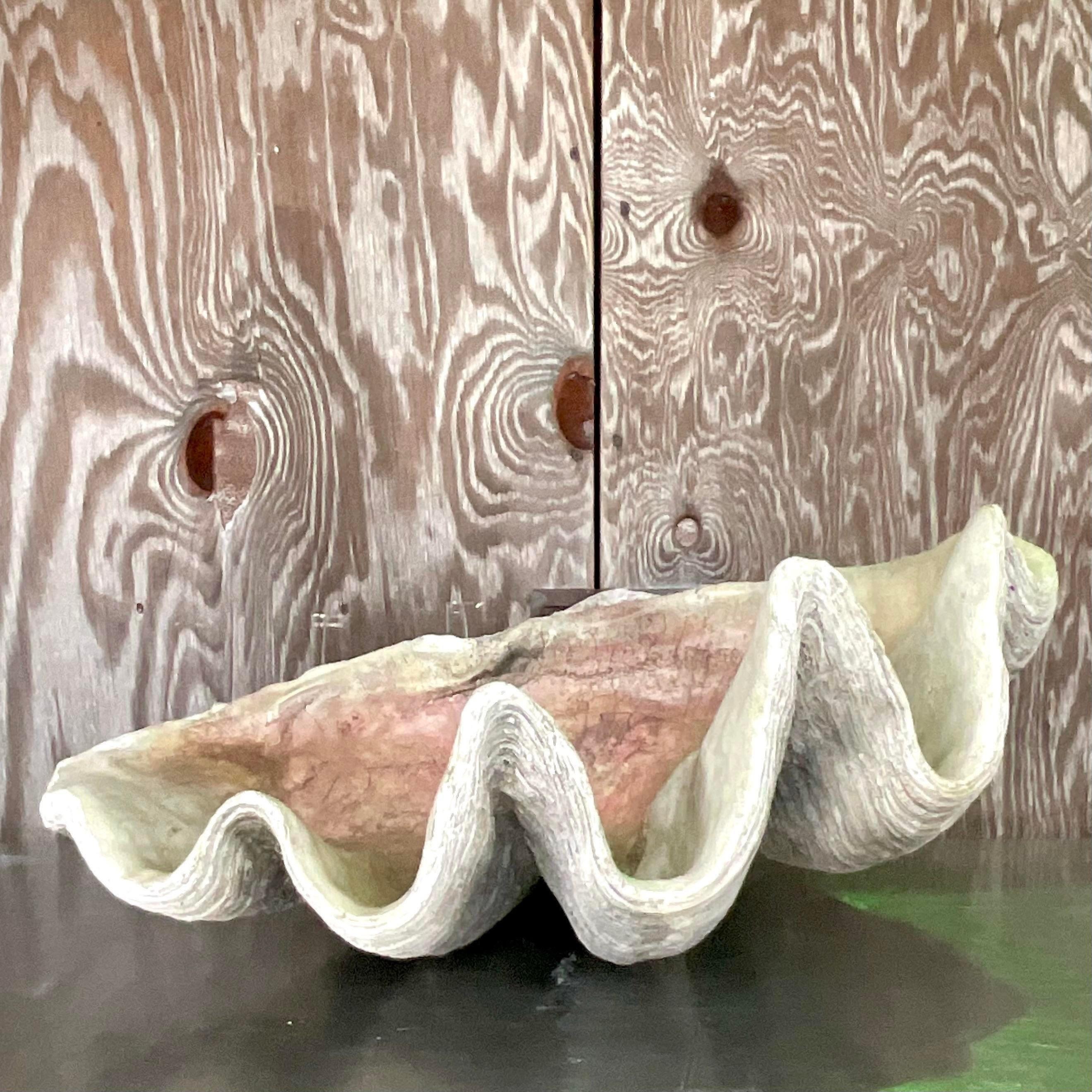 A fabulous vintage Coastal faux clam shell. Monumental in size and drama. A plaster construction with a beautiful patina from time. Acquired from a Palm Beach estate.
