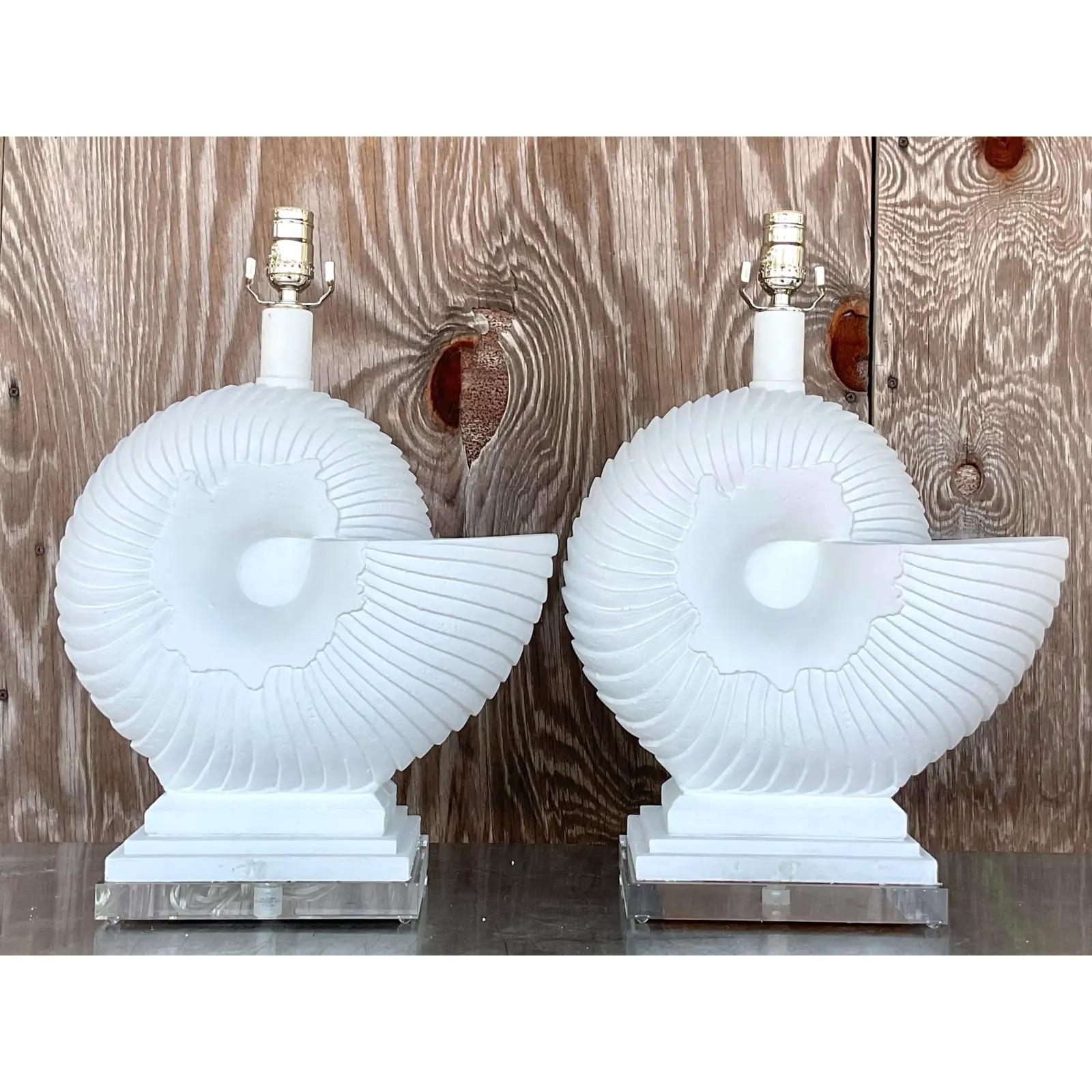 Fantastic pair of vintage Coastal table lamps. Chic nautilus shape with a matte plaster white finish. Fully Restored with all new wiring and chrome hardware. Acquired from a Palm Beach estate.