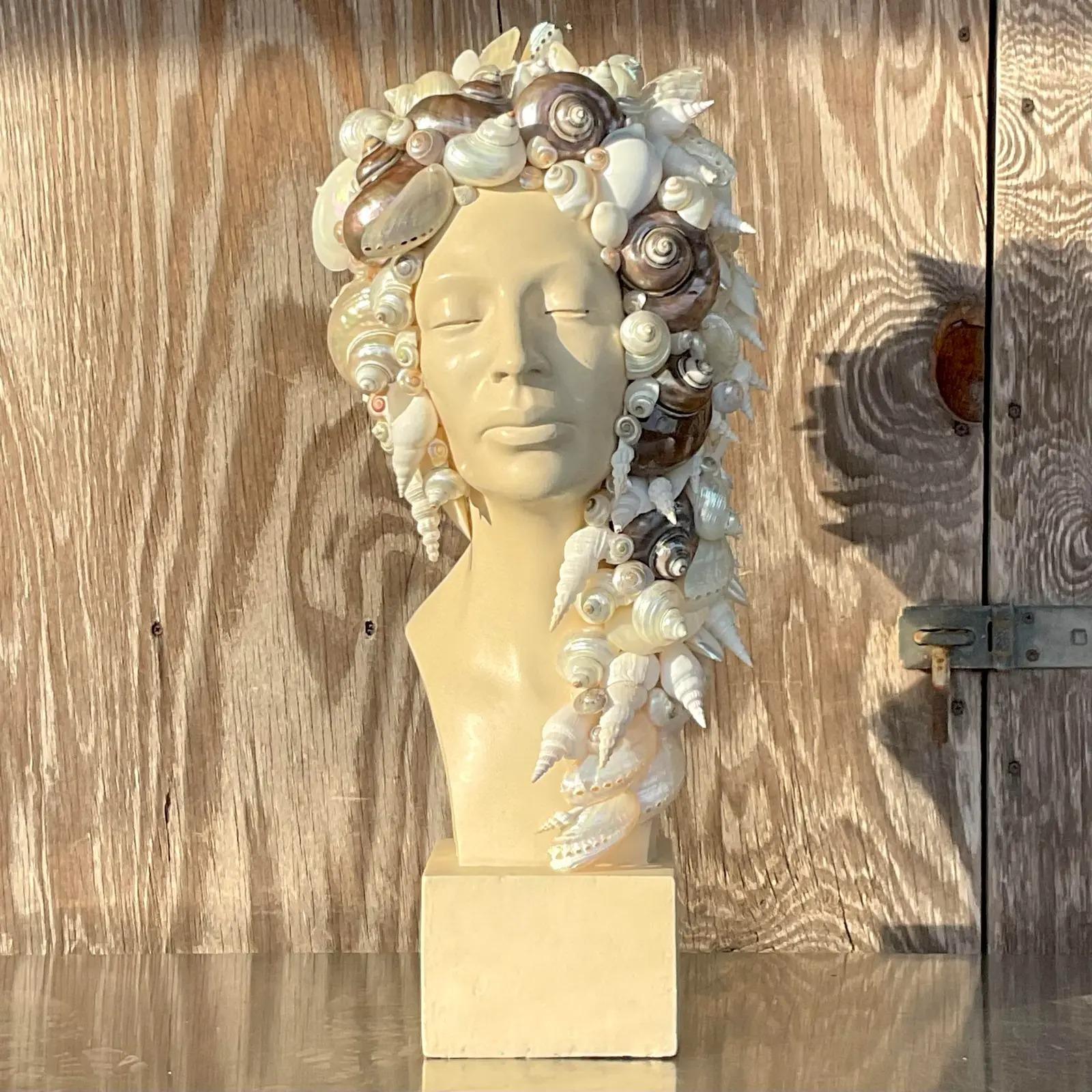 An exceptional vintage Coastal bust of woman. A beautiful profile of a serene woman. A beautiful collection of shells wrap around her head and neck. Acquired from a Palm Beach estate.