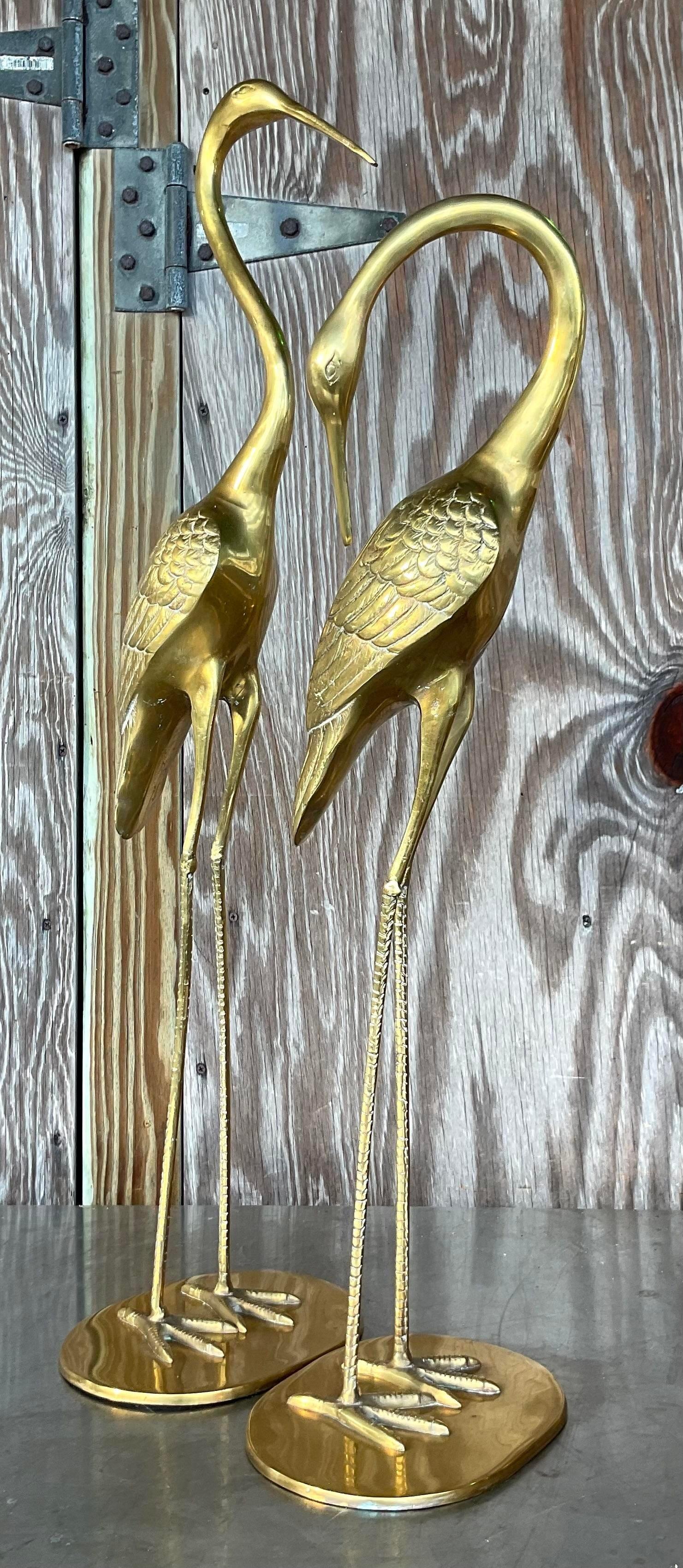 A sensational set of 2 large vintage Coastal cranes. A chic polished brass construction in a bright brass finish. Acquired from a Palm Beach estate.