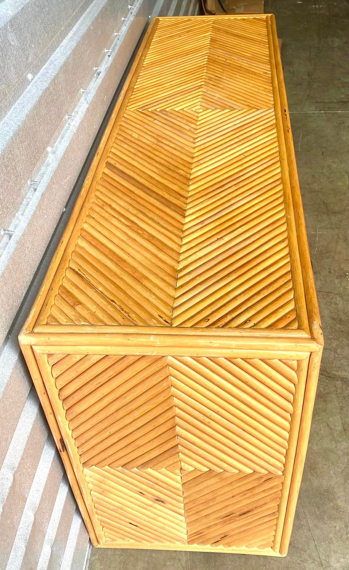 Fabulous vintage pretzel rattan dresser. A brilliant chevron design on all surfaces. Polished brass hardware. Super chic. Acquired from a Palm Beach estate.