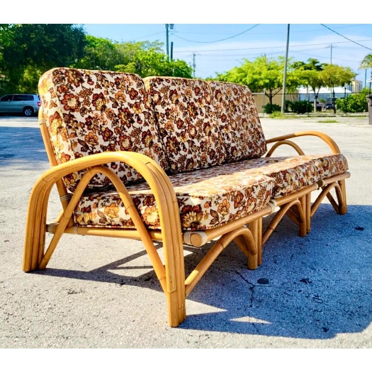 Vintage Coastal Rattan sofa. Three separate pieces put together to make one piece. Fantastic vintage printed upholstery. Acquired from a Miami estate.