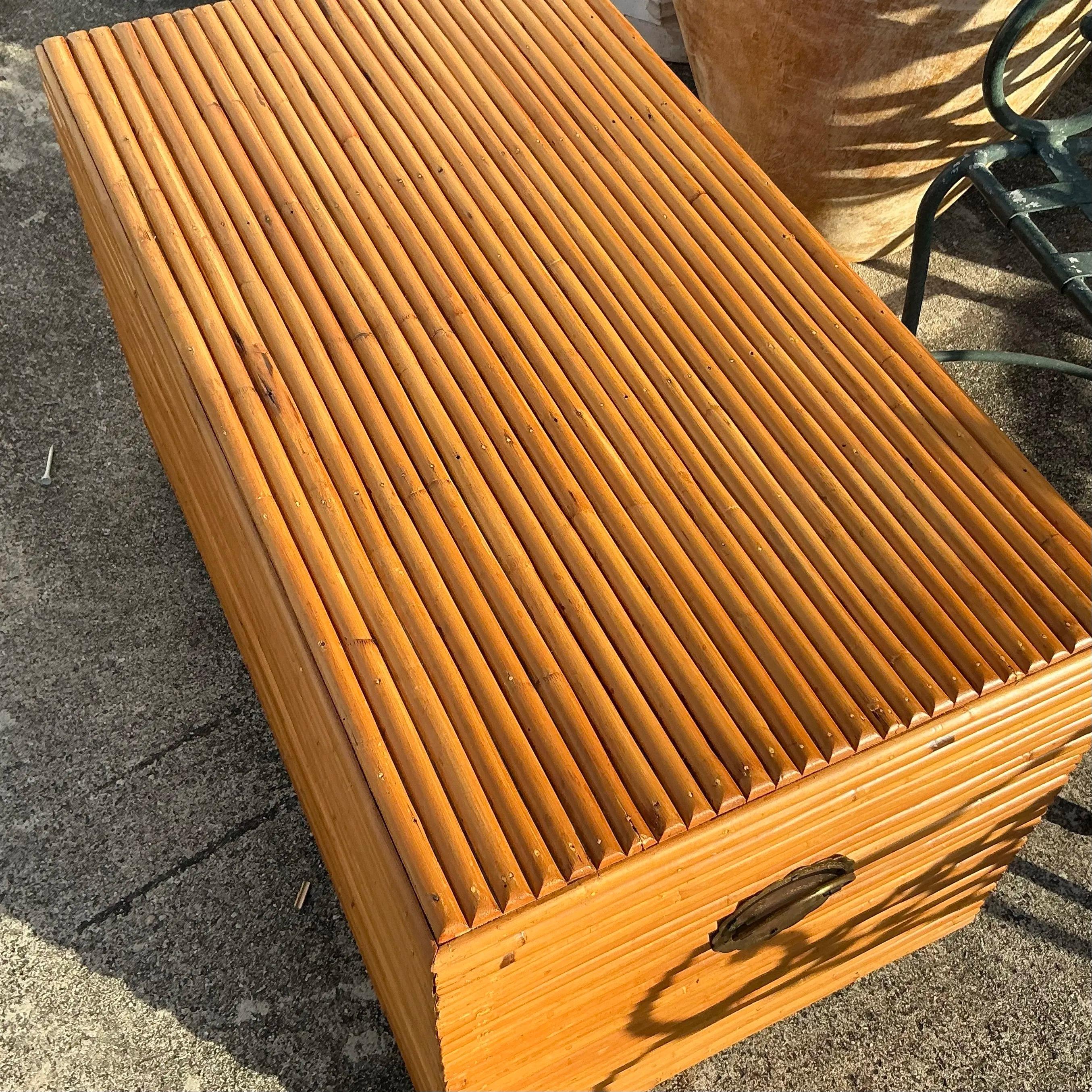 Elevate your storage solutions with this Vintage Coastal Pretzel Rattan Trunk. Showcasing an artful design, this trunk is crafted from tightly woven rattan accented with iconic pretzel-shaped detailing, embodying coastal charm and timeless