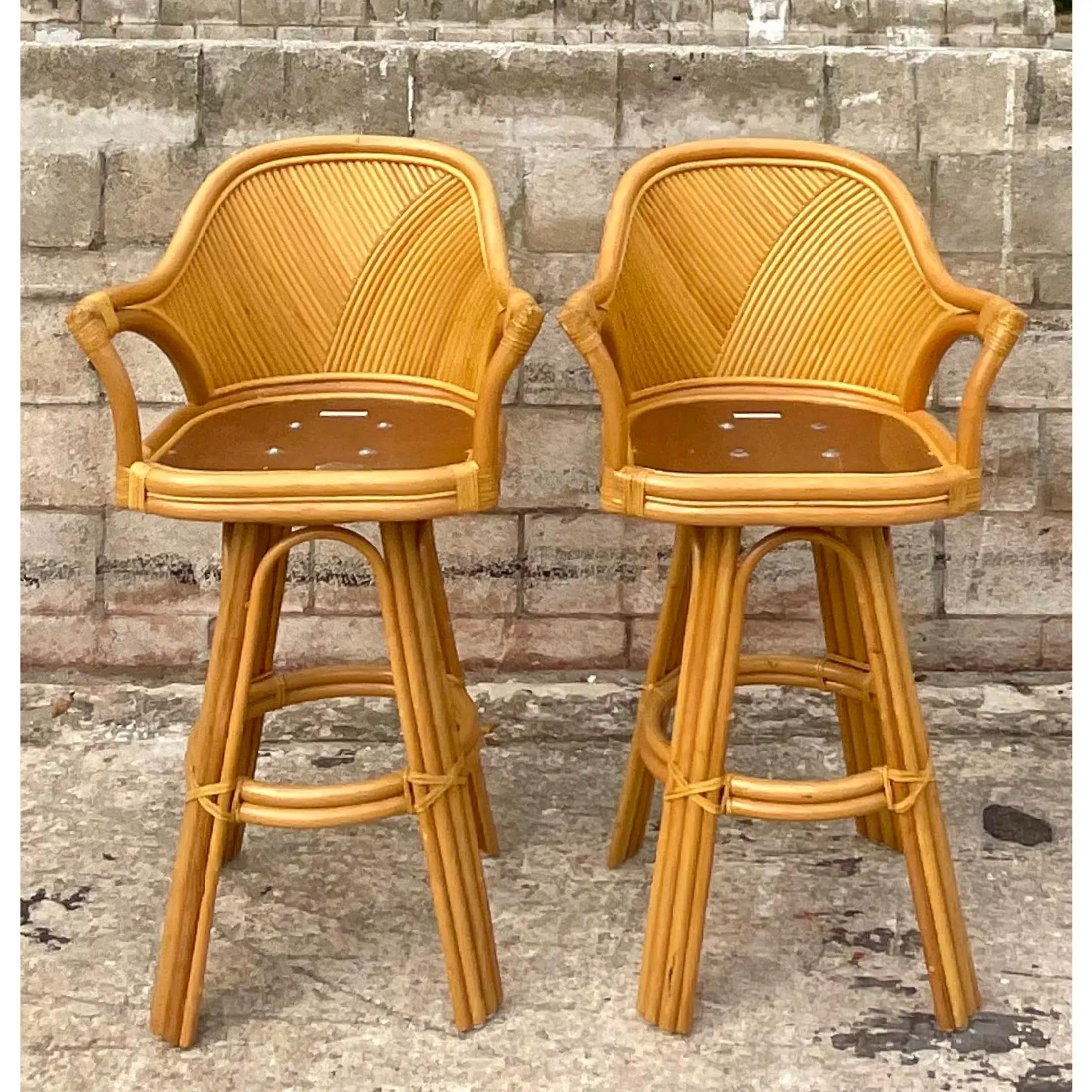 Vintage pair of Coastal swivel barstools. Beautiful bright pretzel reed in a chic arched design. Great sturdy stools. Acquired from a Palm Beach estate