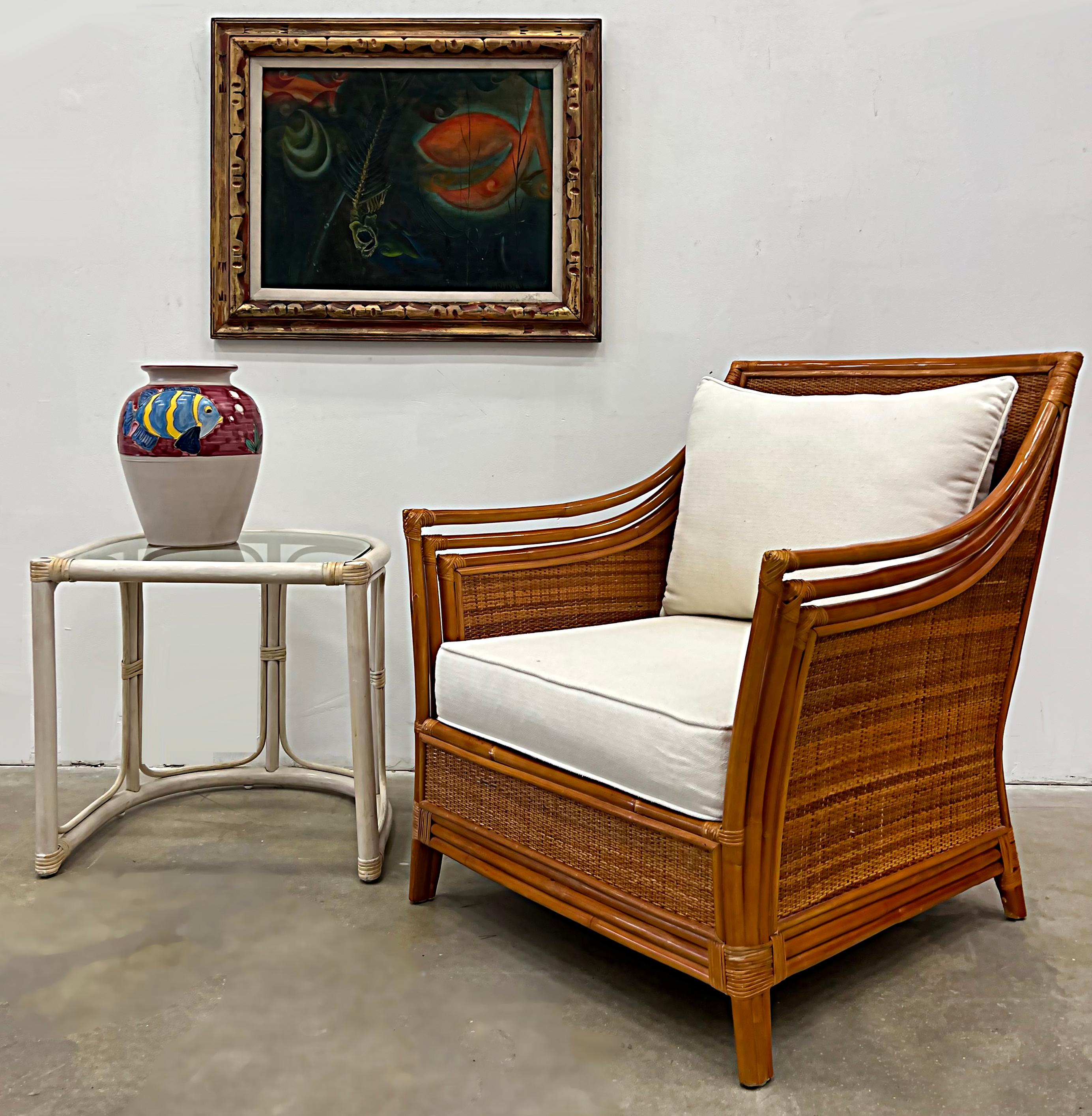 Vintage coastal rattan and wicker lounge chair 

Offered for sale is a vintage Coastal lounge chair that has a stylish rattan and woven wicker frame. The elegantly curved frame supports loose cushions and has wrapped joints. The cushions are