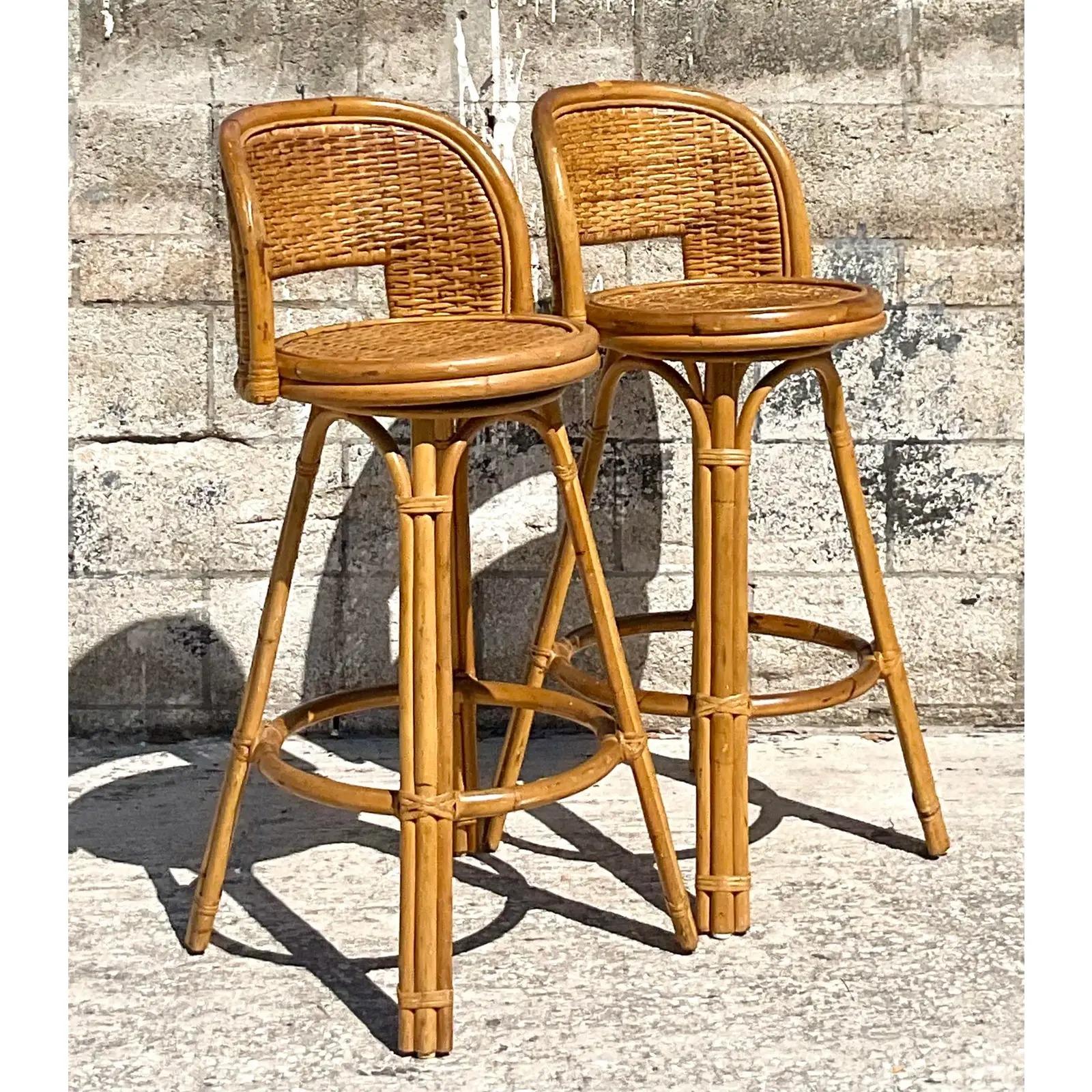 A fabulous pair of vintage Coastal bar stools. Beautiful classic rattan frame in a classic design. Acquired from a Palm Beach estate.