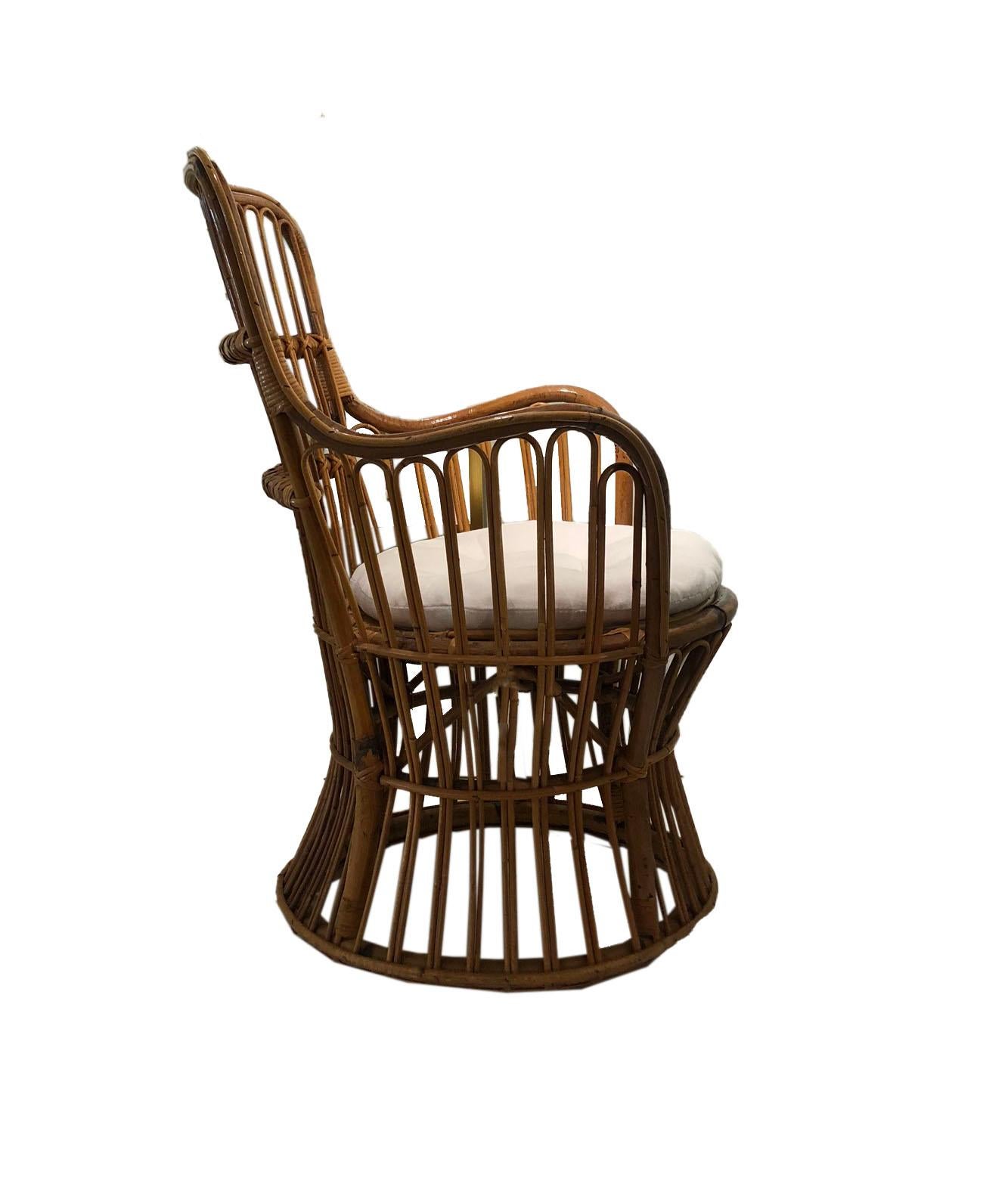 This medium scale rattan chair is a perfect example of its midcentury beginnings. A comfortable seat and new upholstery allow this chair to mix with many styles and become a comfortable place to sit in your home!