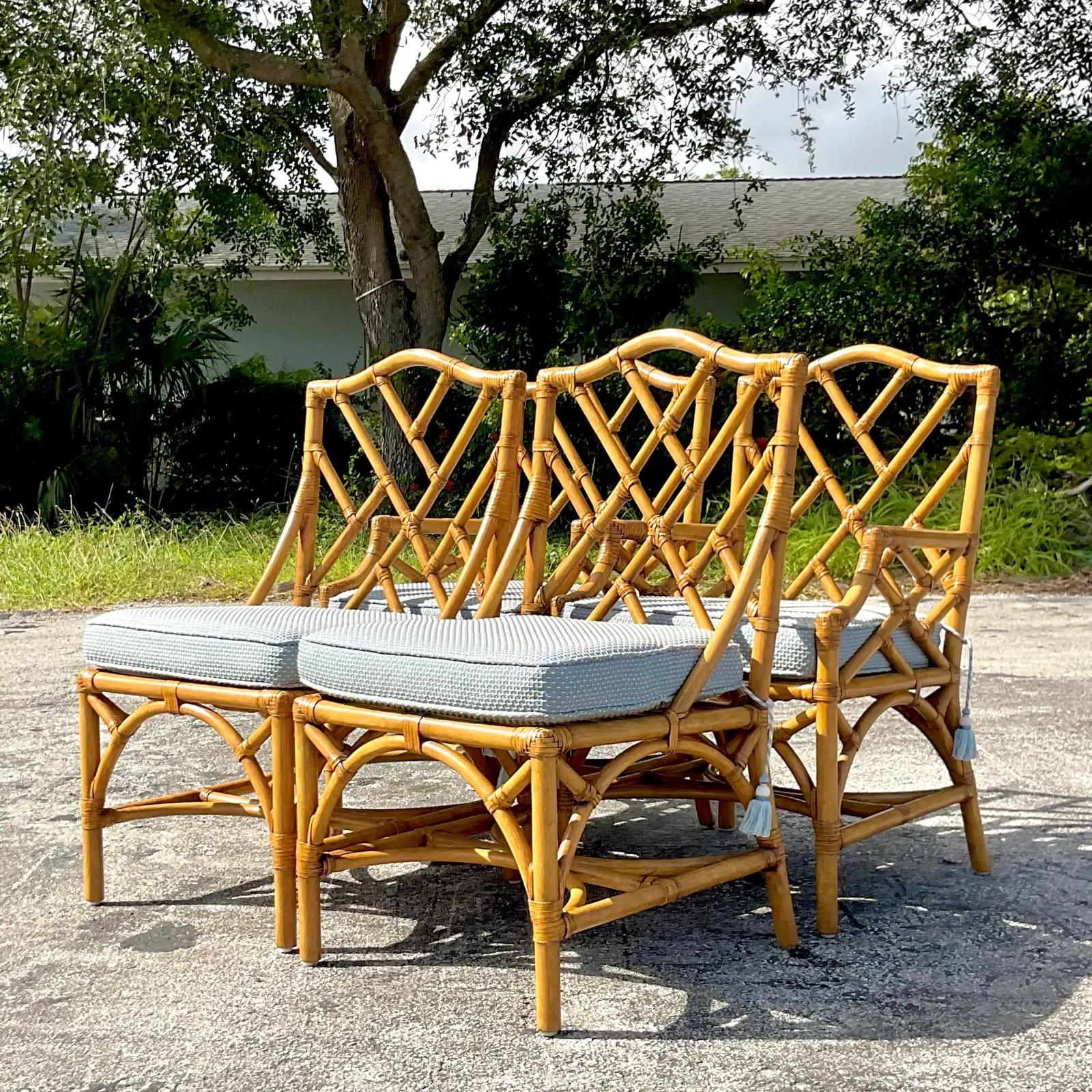 A fabulous set of Coastal dining chairs. Beautiful Chinese Chippendale design with custom cushion with tassel ties. Two arm chairs and two sides. Acquired from a Palm Beach estate.
