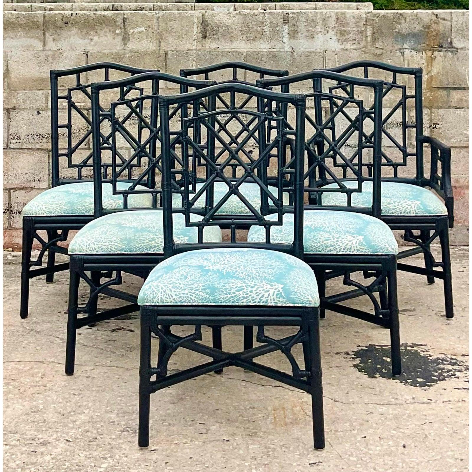 Fantastic set of 6 coastal rattan dining chairs. Iconic Chinese Chippendale fretwork design with a beautiful pale blue coral print upholstery. Matte black paint with all wraps intact. A gorgeous set with two arm chairs and six sides.