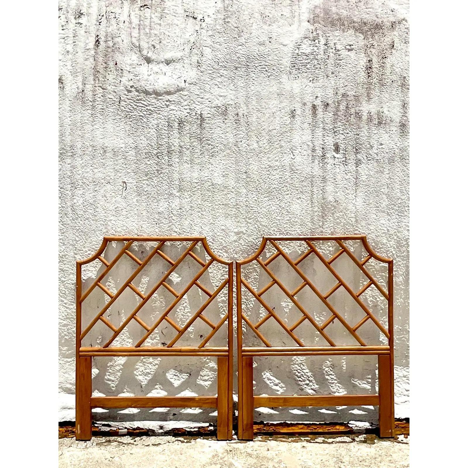 Fantastic pair of vintage Coastal twin headboards. Beautiful Chinese Chippendale design in heavy rattan. Acquired from a Palm Beach estate.