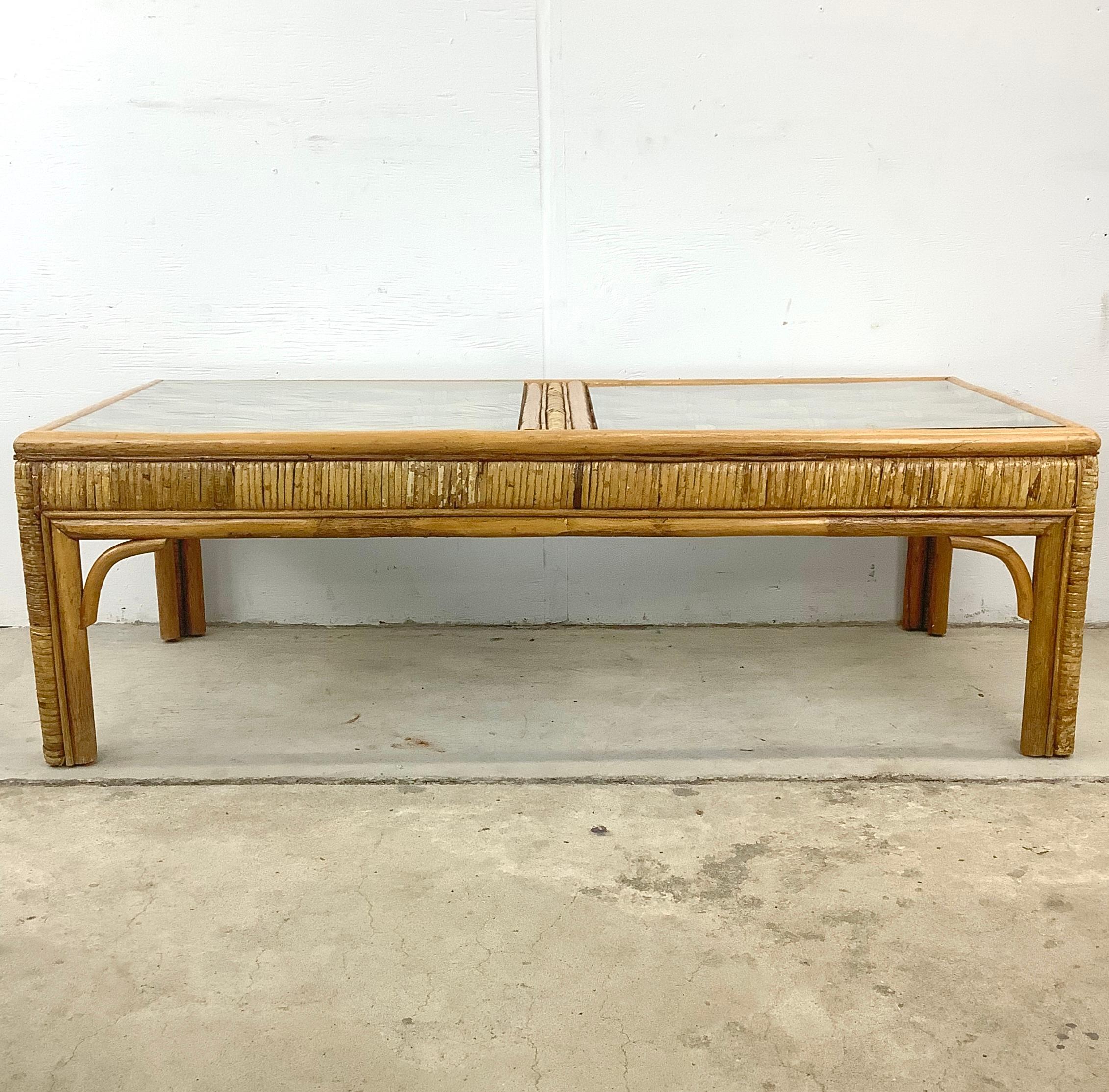 Elevate your living space with this Vintage Bamboo Coffee Table, a testament to the enduring allure of coastal design. Crafted in the 1970s, this table epitomizes the timeless elegance and unparalleled craftsmanship of the era. Its bamboo structure,