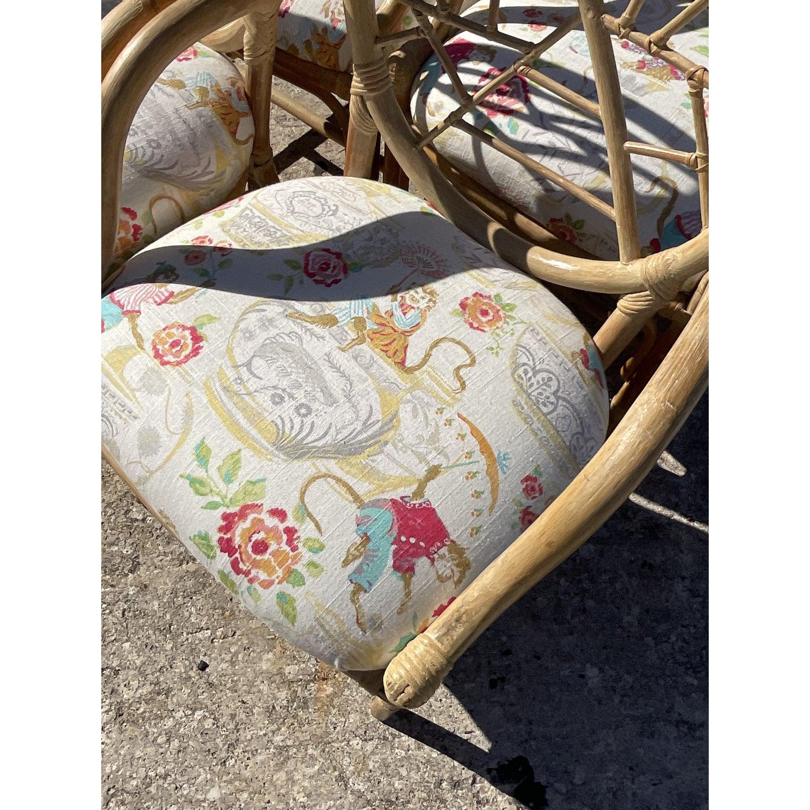 Gorgeous set of four bent rattan dining chairs. A chic light cerused finish In the iconic “Cracked Ice” design. Done in the manner of McGuire. Fabulous chinoiserie printed upholstery with charming monkeys at play. Acquired from a Palm Beach estate.