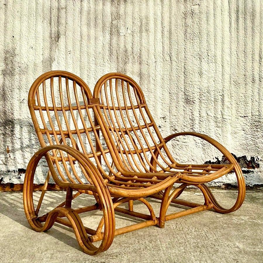 This stunning vintage rattan double lounge chair embodies the relaxed elegance of coastal design. With its gracefully curved frame and natural rattan construction, this piece offers both style and comfort. The open-weave design allows for an airy,