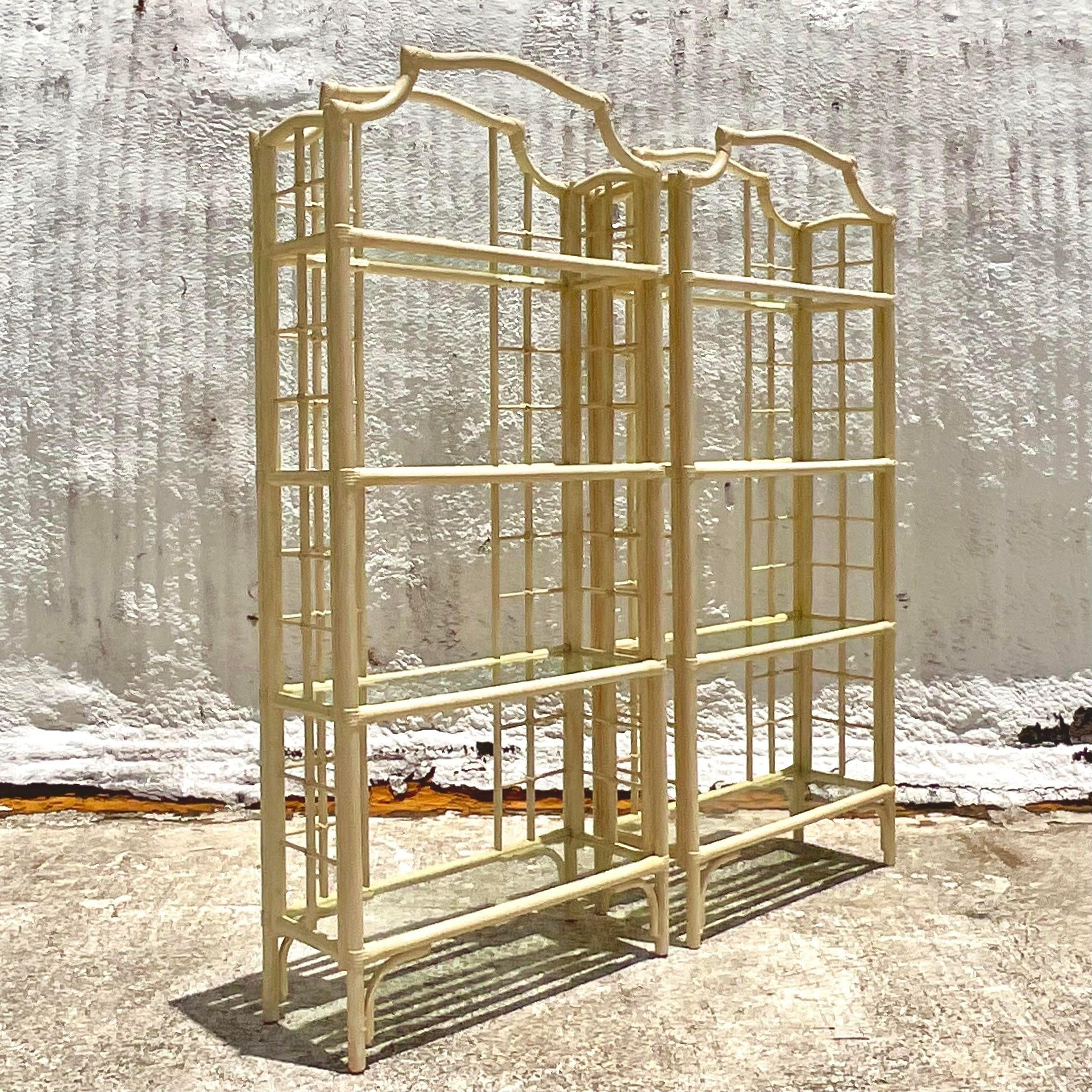 A fabulous pair of vintage Coastal etagere. Beautiful notched top design in a pale yellow finish. Perfect as is or paint to suit your project. You decide! Inset glass shelved. Acquired from a Palm Beach estate.