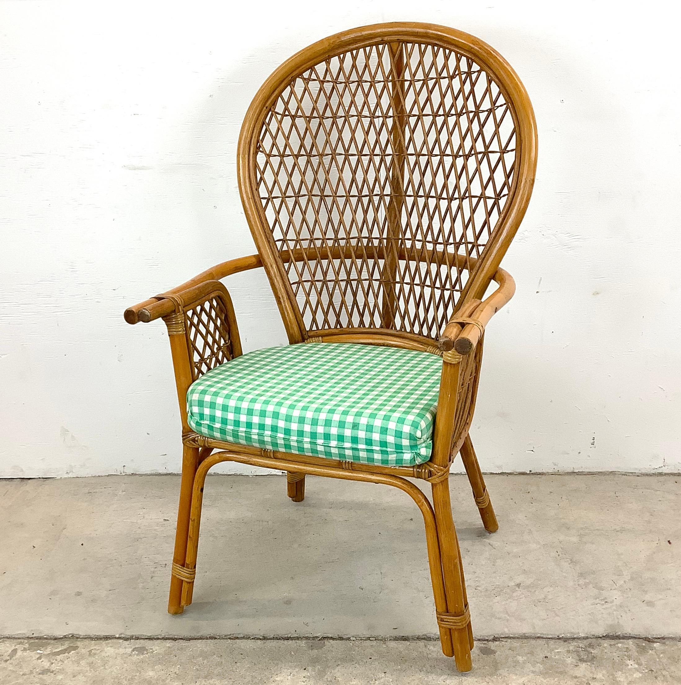 Experience the relaxed sophistication of coastal living with this Vintage Rattan Armchair, a piece that echoes the laid-back elegance of a seaside retreat with the refined flair of the fanback seat style. This armchair is a masterpiece of natural