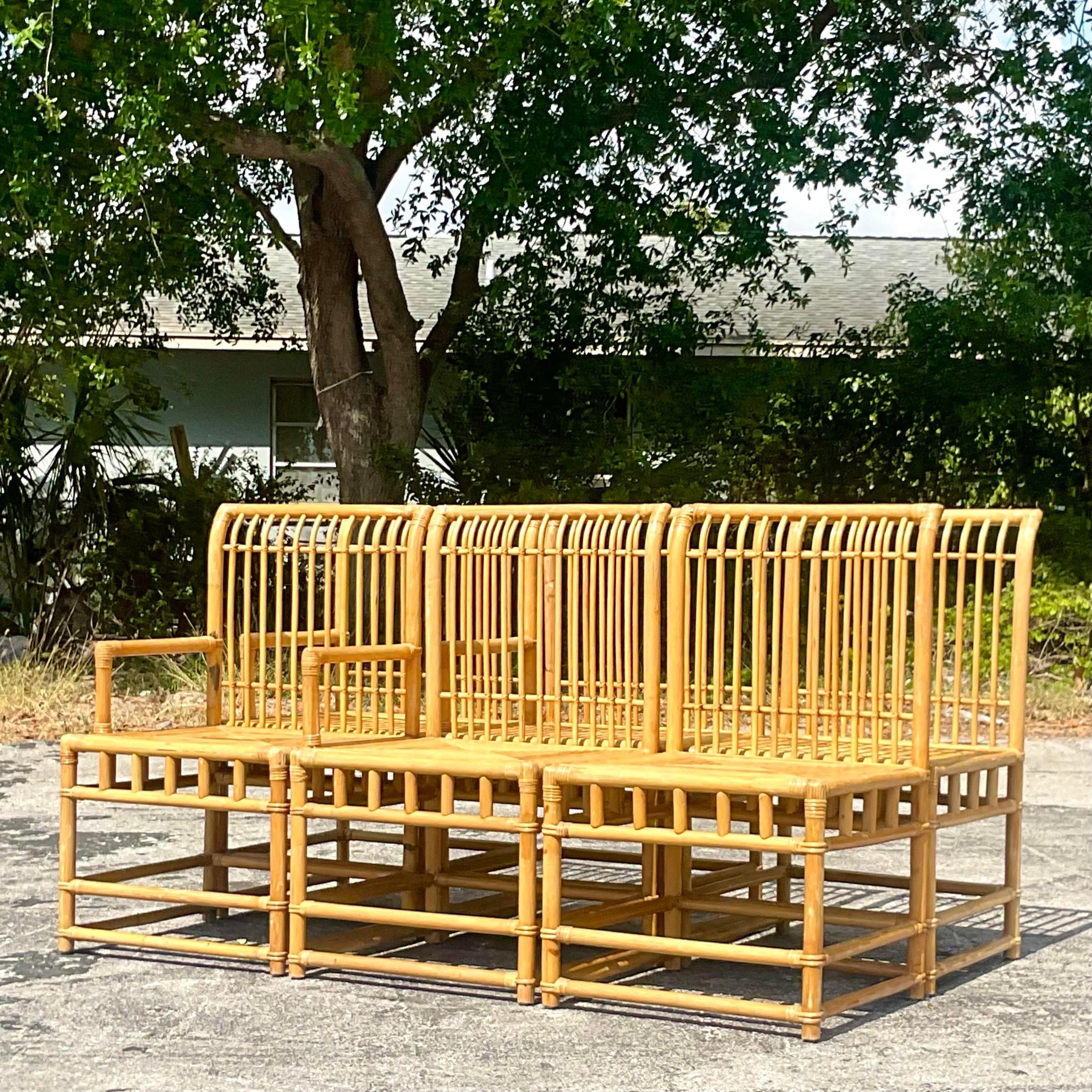 An exceptional set of six rattan high back dining chairs. Done in the manner of the McGuire group. Wide bottom seats for extra comfort. Two arm chairs and four sides. Acquired from a Palm Beach estate.