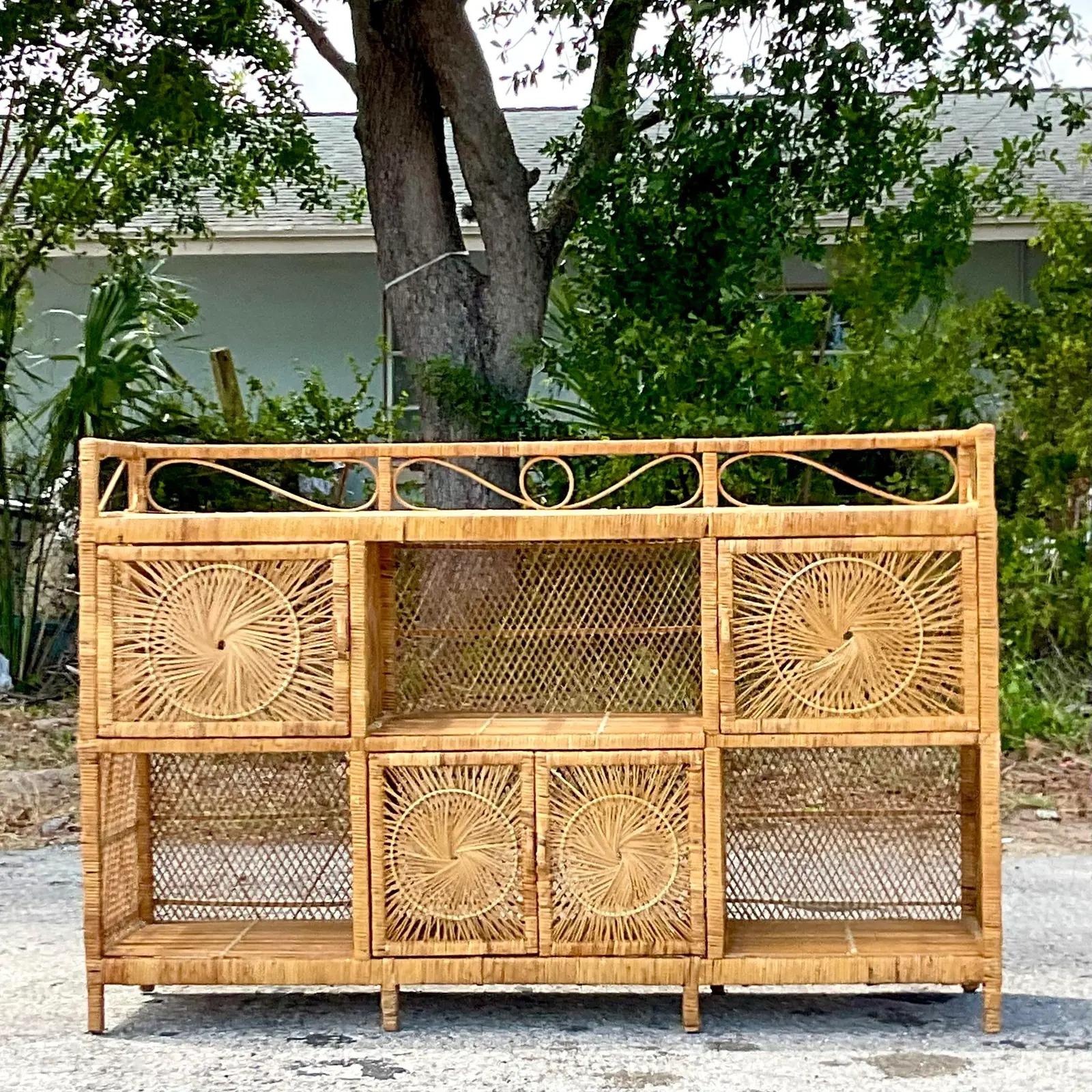 A fabulous vintage Coastal credenza. Beautiful open weave construction with lots of great storage below. The coveted Starburst design on all the door fronts. Acquired from a Palm Beach estate.