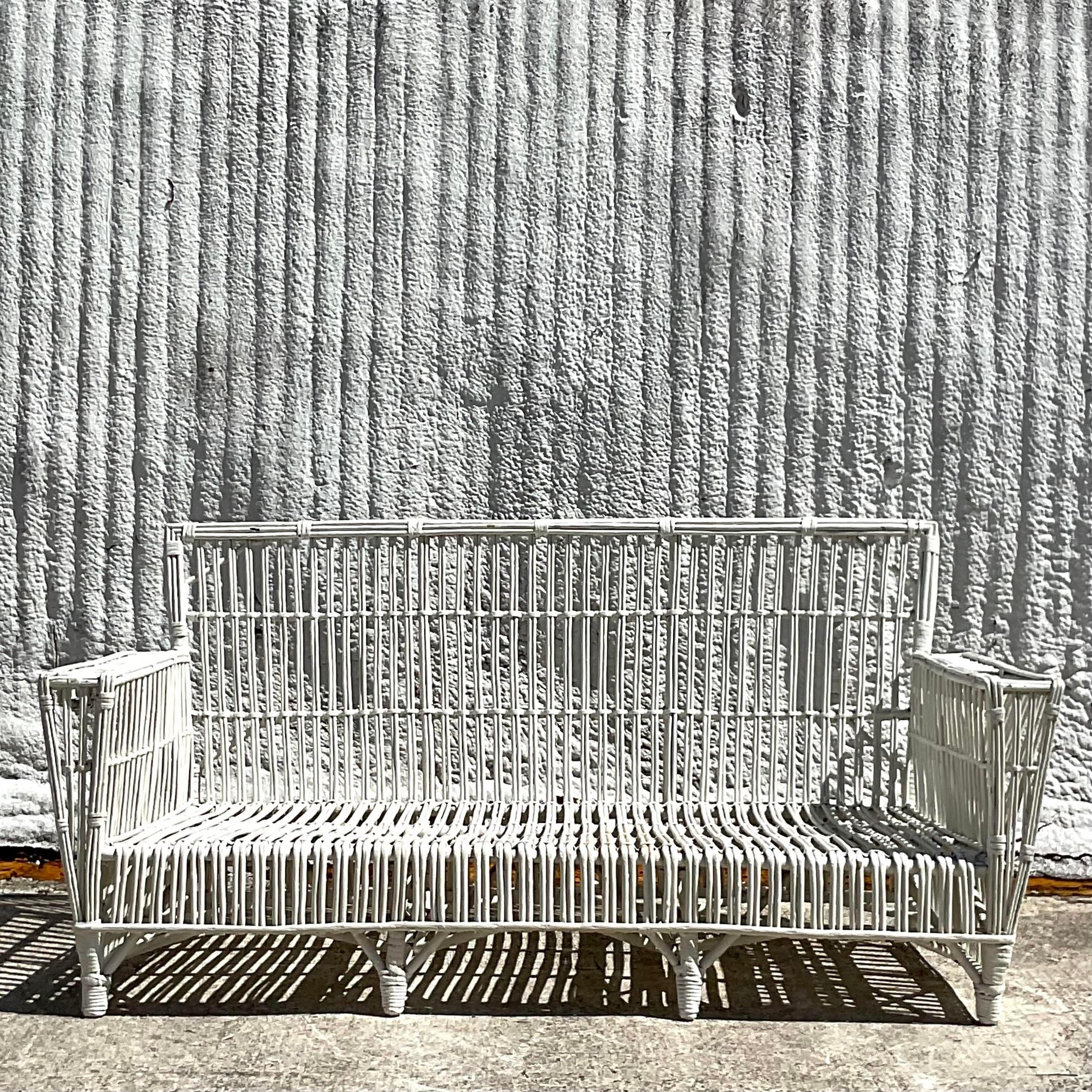A fabulous vintage Coastal stick rattan sofa. Done in the manner of the iconic Bielecky Brothers. Fabulous vintage all over patina from time. Lots of cool layers of paint give it that authentic look. Acquired from a Palm Beach estate.