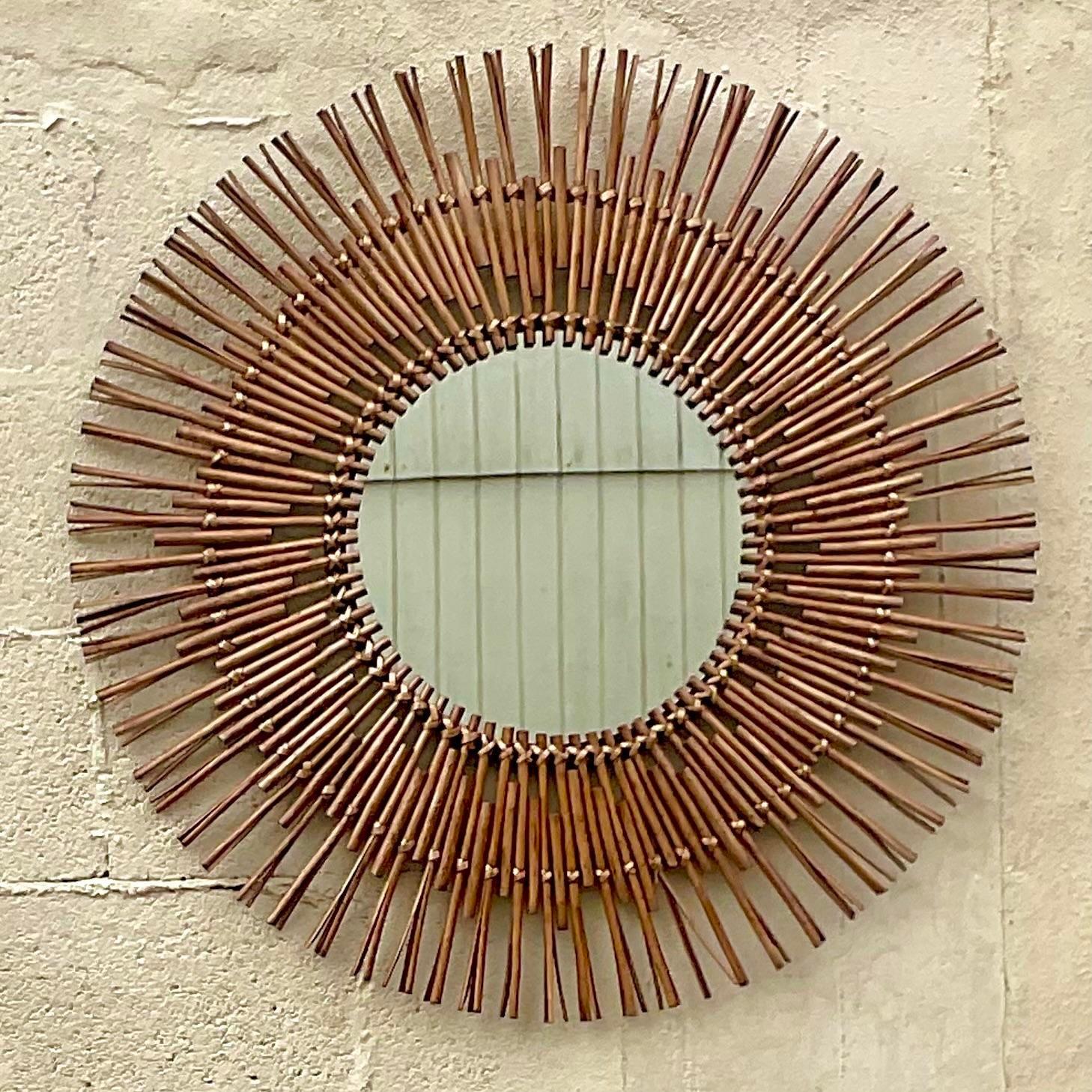 A fabulous vintage Coastal wall mirror. A chic starburst rattan design. Acquired from a Palm Beach estate.