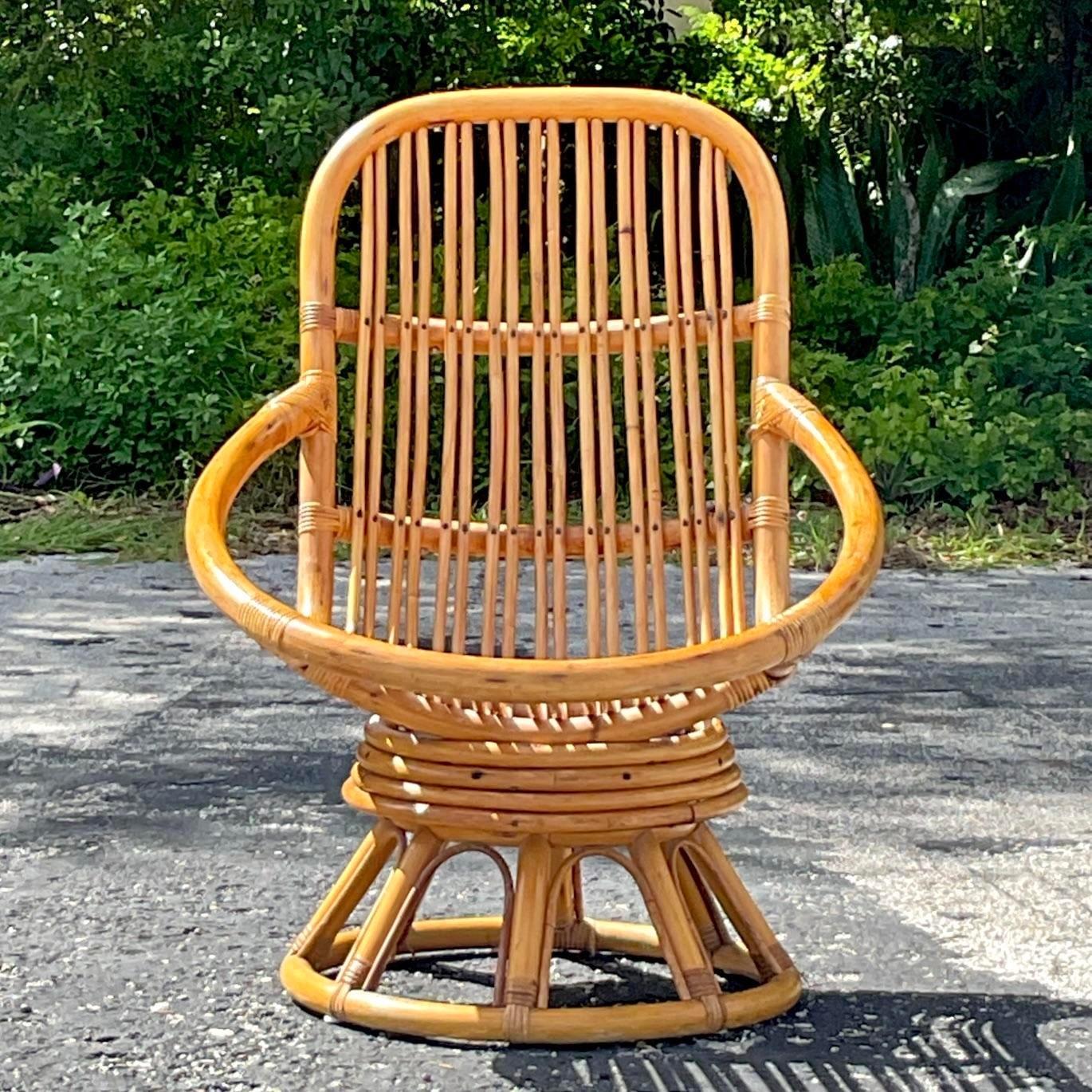 A fabulous vintage Coastal lounge chairs. A chic swivel design in a classic hoop shape. The perfect place to kick back and relax. Acquired from a Palm Beach estate. 