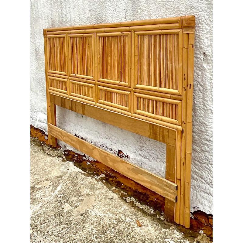 A Vintage Coastal queen headboard. A chic and simple design that lets the beauty of the rattan stand out. Acquired from a Palm Beach estate.