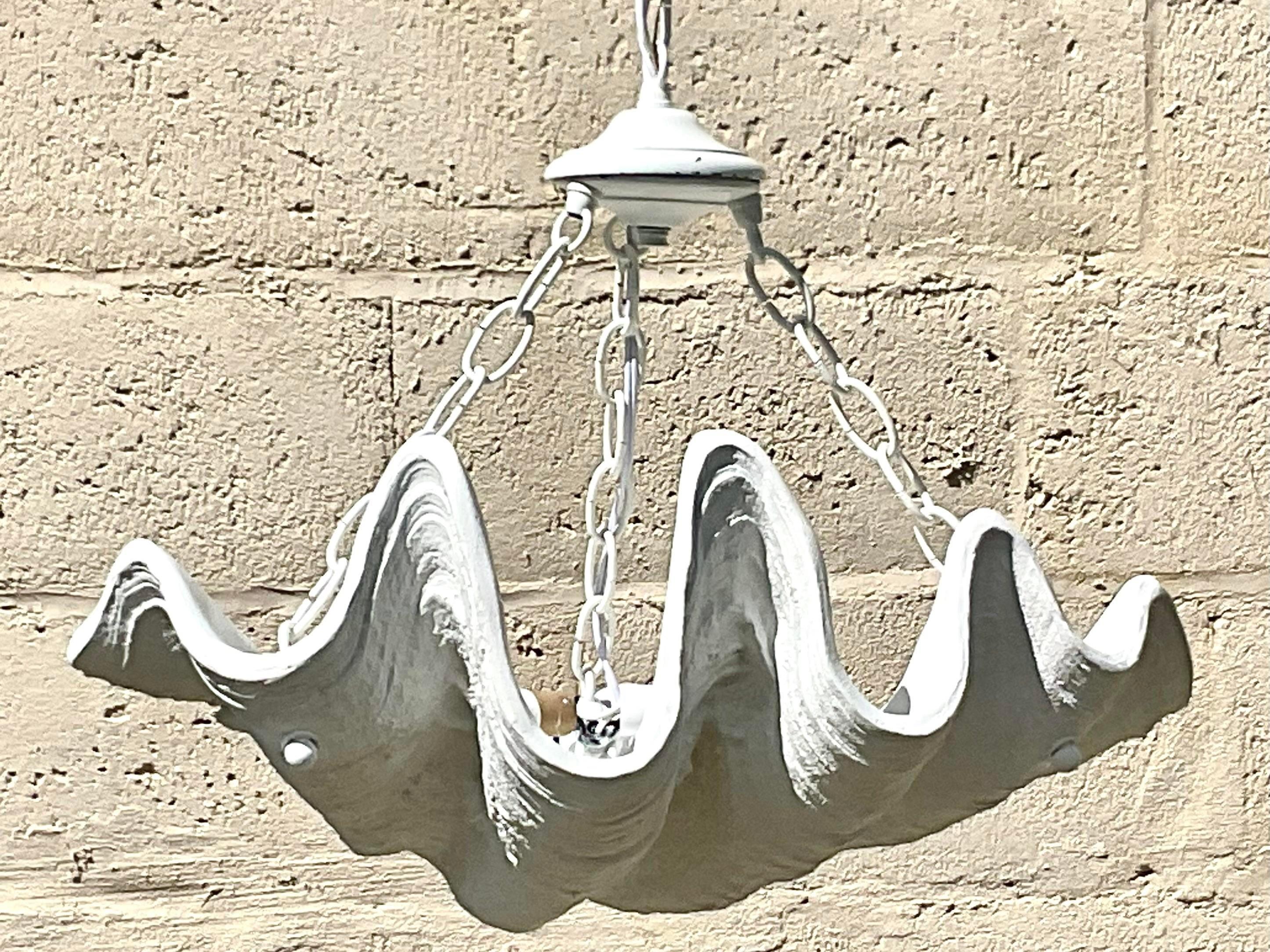 A fantastic vintage Coastal chandelier. A resin giant clam shell in a matte plaster white. A fantastic look for a powder room or entry. Newly rewired and all new hardware. Acquired from a Palm Beach estate.