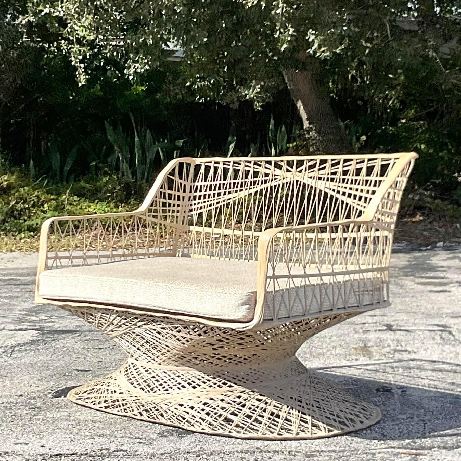 A fantastic vintage Coastal outdoor loveseat. Made by the iconic Russell Woodard. Unmarked. Custom cushion also included. Acquired from a Palm Beach estate.