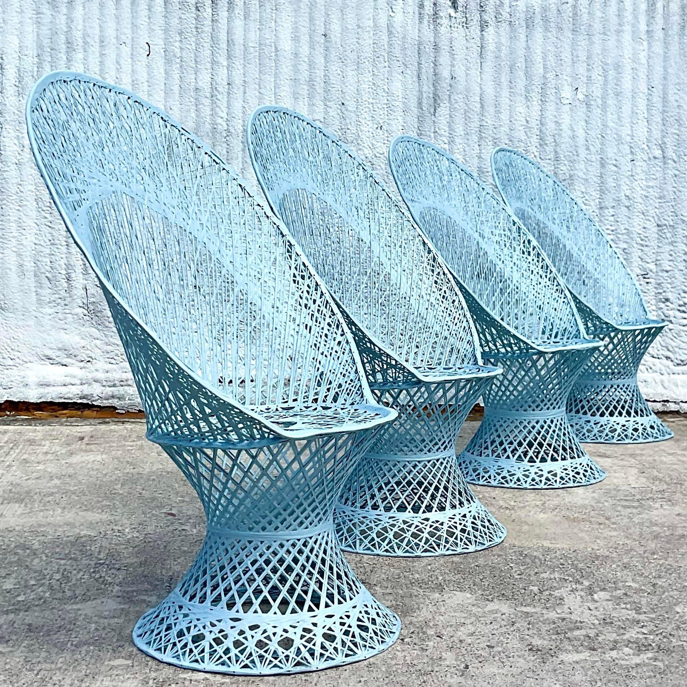 A fantastic set of four vintage MCM outdoor peacock chairs. Made by the iconic Russell Woodard in his famous spun fiberglass construction. Freshly lacquered a pale blue. Acquired from a Palm Beach estate.