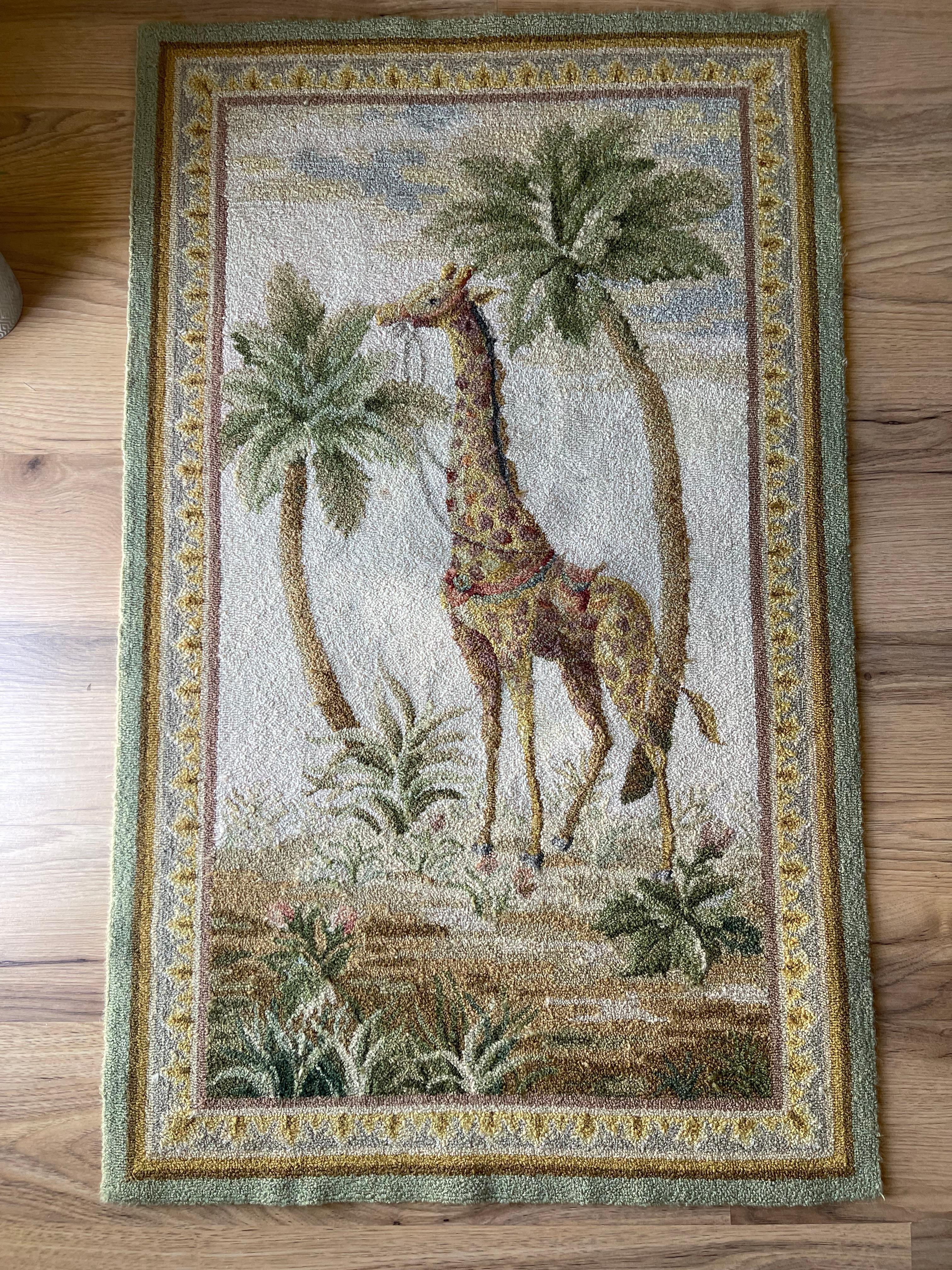 Vintage hooked rug in the style of coastal safari  with a giraffe in palm trees landscape. Nice muted color palette. Great condition. Cleaned without Cho. Great for a safari themed or any children’s interior.