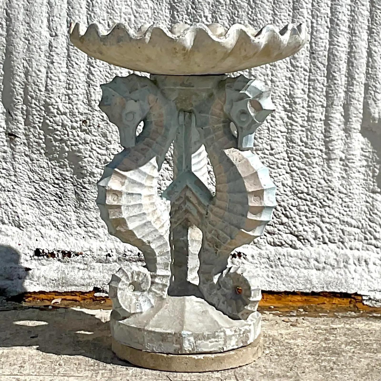 A spectacular vintage Coastal cement birdbath. The coveted trio of seahorses with the remains of an older pale blue paint. The overall effect is so good. Acquired from a Palm Beach estate.

The birdbath is in great vintage condition. Chips and