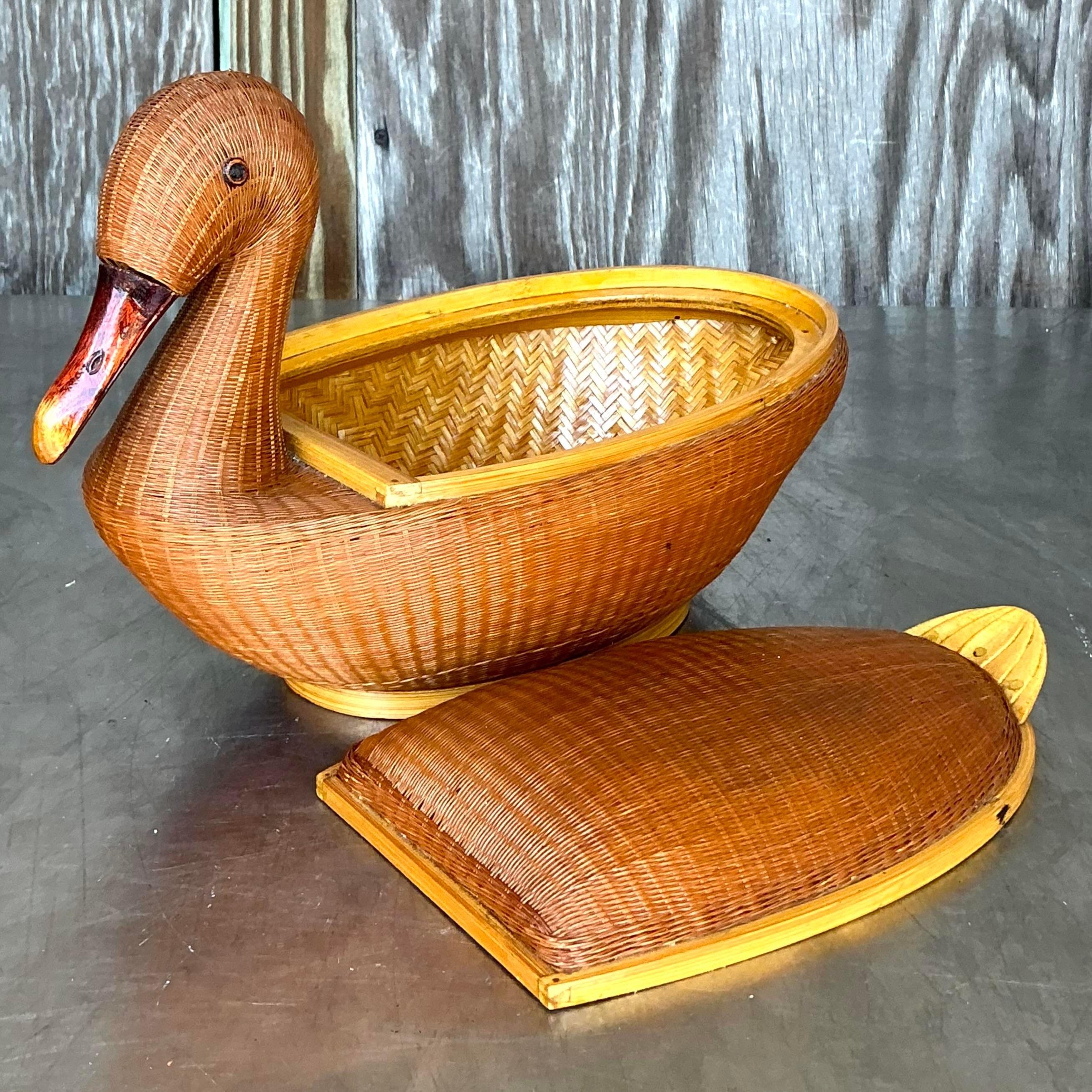 Add a charming touch of coastal elegance to your home with this unique vintage Shanghai weave duck basket. This finely crafted wicker basket features a delightful duck design with a removable lid, perfect for both functionality and style. The