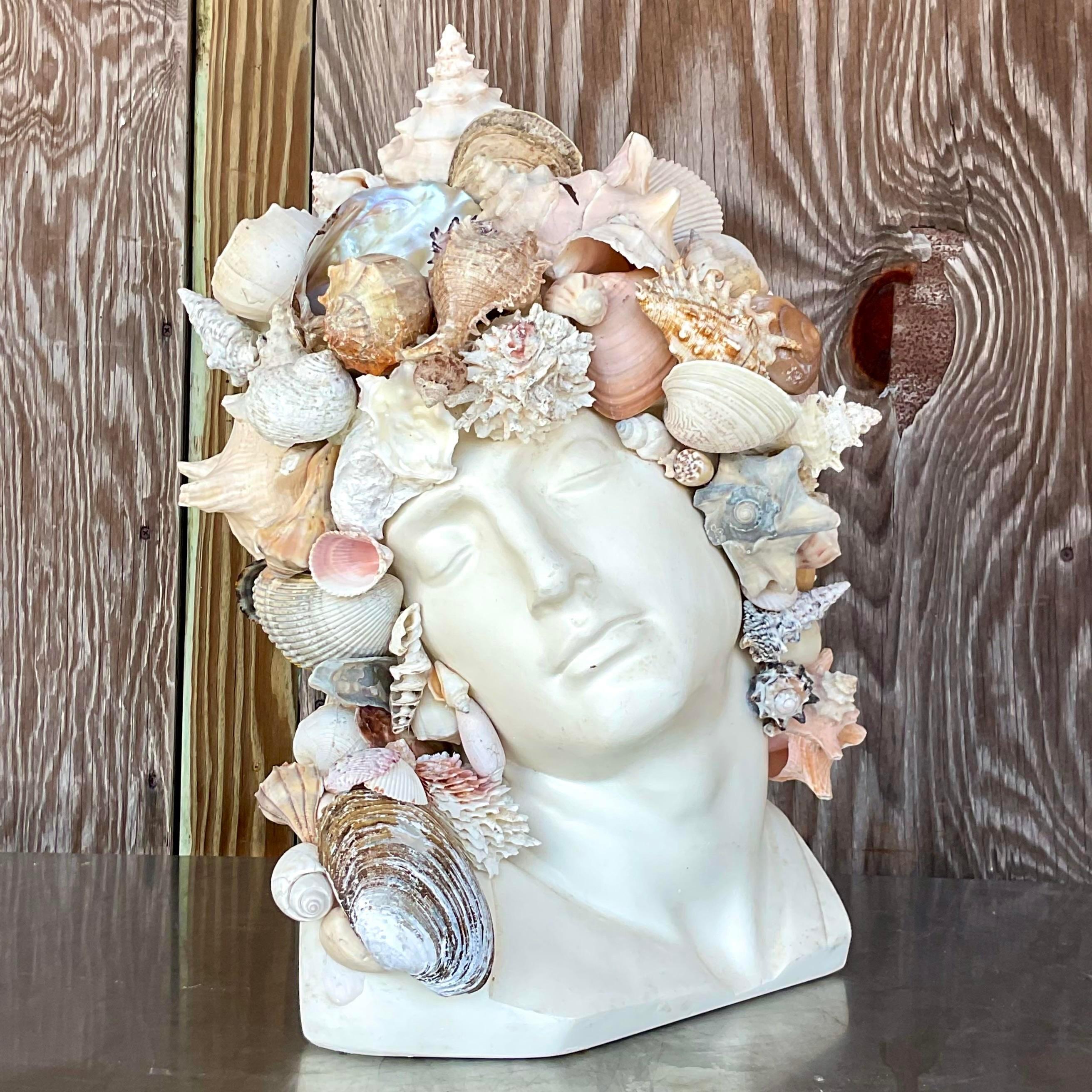 A stunning vintage plaster bust. A chic Shell encrusted man with all large and interesting shells. Sure to be the focal point of any space. Just add a plinth for extra drama. Acquired from a Palm Beach estate.
