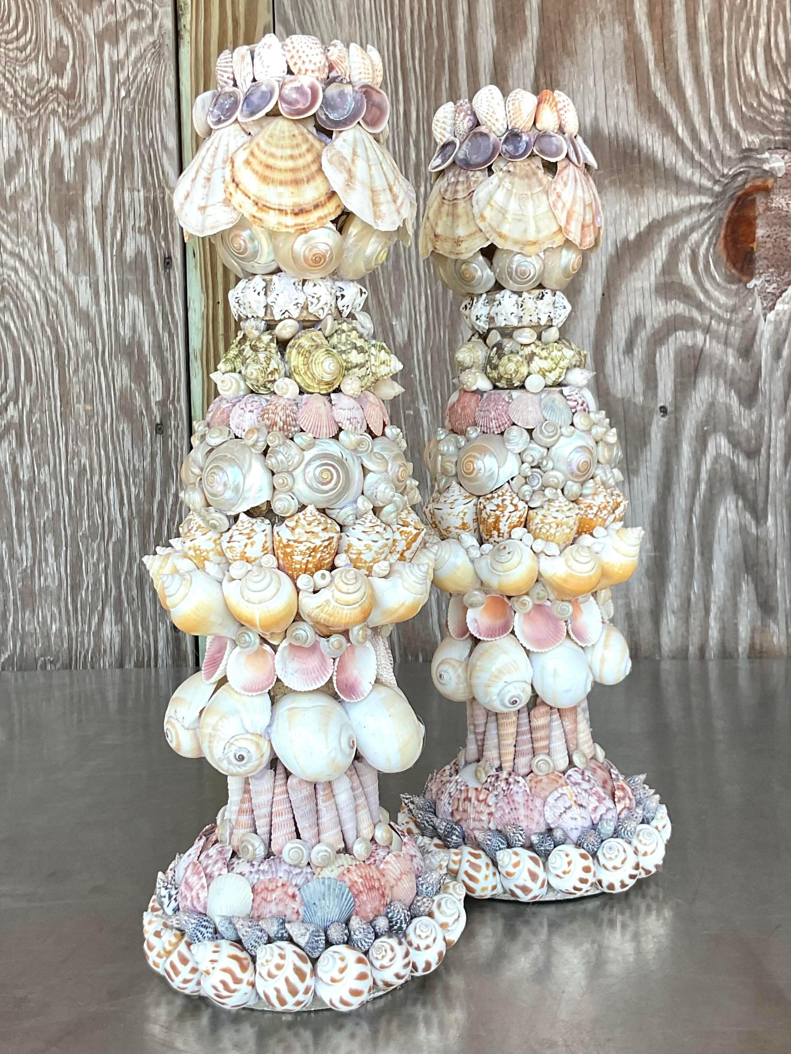 Illuminate with seaside charm using our Vintage Coastal Shell Encrusted Candlesticks - A Pair. These elegant candlesticks are adorned with shells, blending coastal allure with American elegance. A perfect duo that adds a touch of coastal