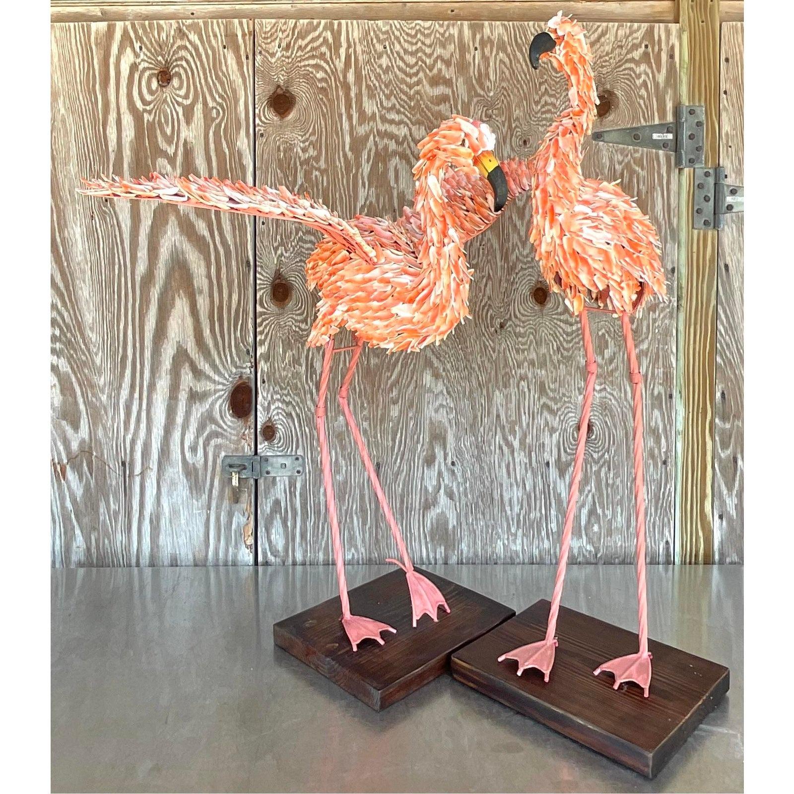 A fabulous set of two vintage Coastal flamingos. Hand encrusted with the most beautiful pink shells. Stand on wooden plinths. These are indoor birds thst will add a little tropical charm to any space. Acquired from a Palm Beach estate.

Second