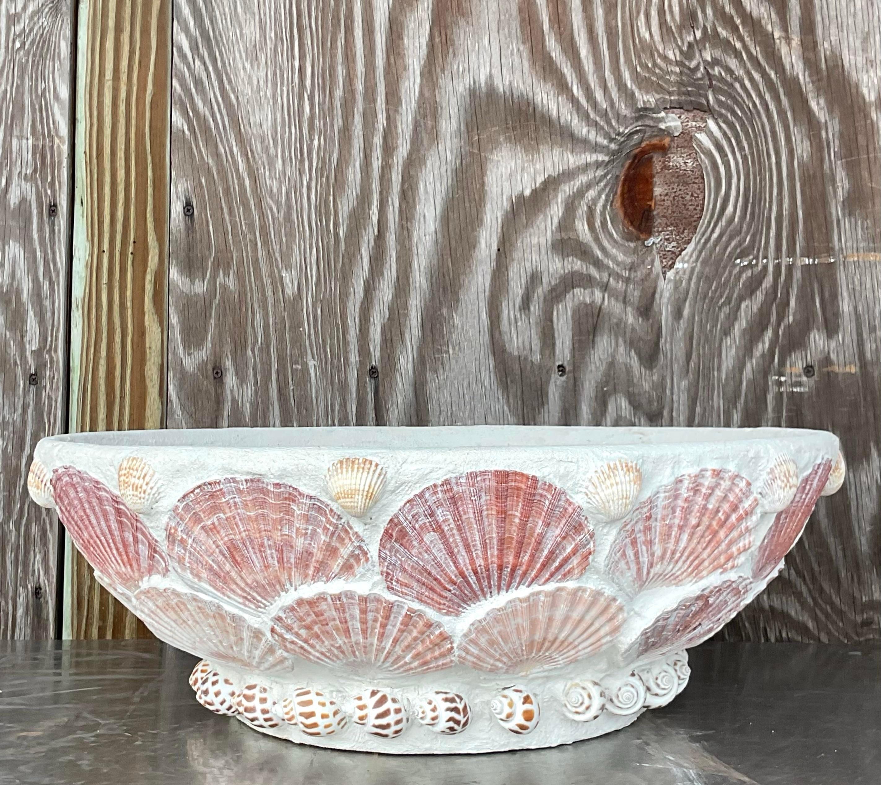 Bring a touch of seaside charm to your home with our Vintage Coastal Shell Encrusted Planter. Crafted with American ingenuity and adorned with natural treasures, it's the perfect fusion of elegance and coastal allure.