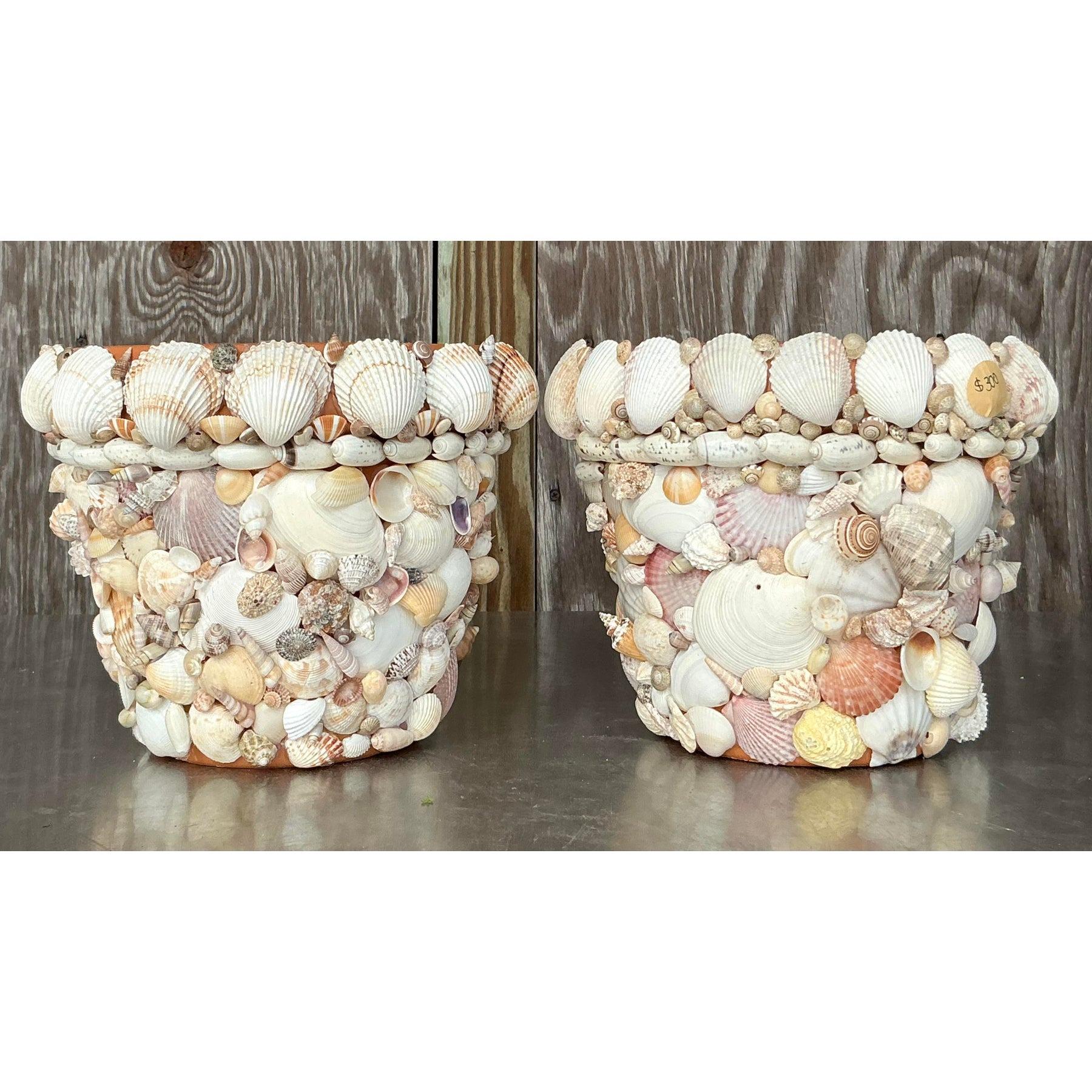 Bring coastal charm into your home with this vintage shell-encrusted planter. Adorned with an array of delicate shells, this planter showcases natural seaside beauty, perfect for enhancing the look of any indoor or outdoor space. Its sturdy design