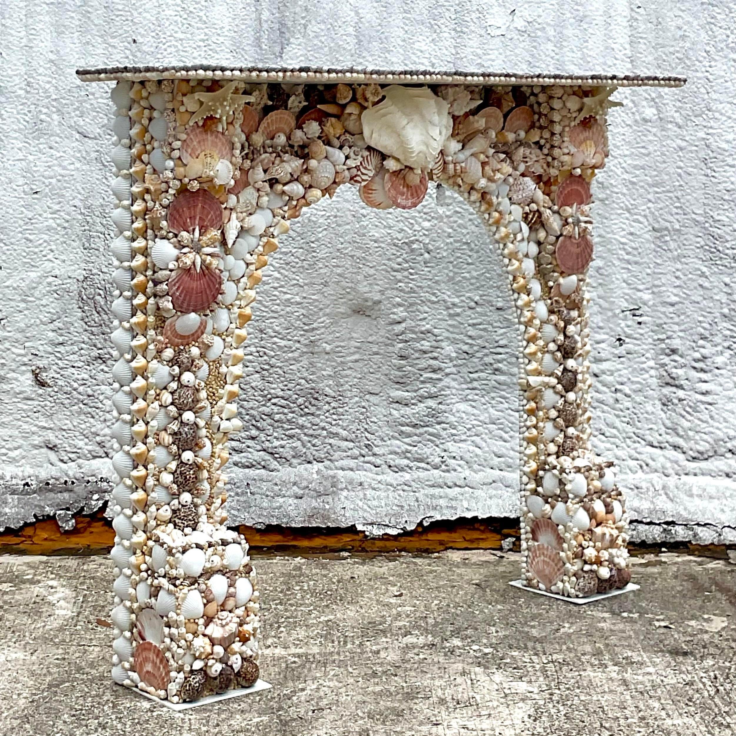 A, extraordinary Coastal fireplace mantle. A chic vintage surround covered with hand placed shells. A true masterpiece. Acquired from a Palm Beach estate.