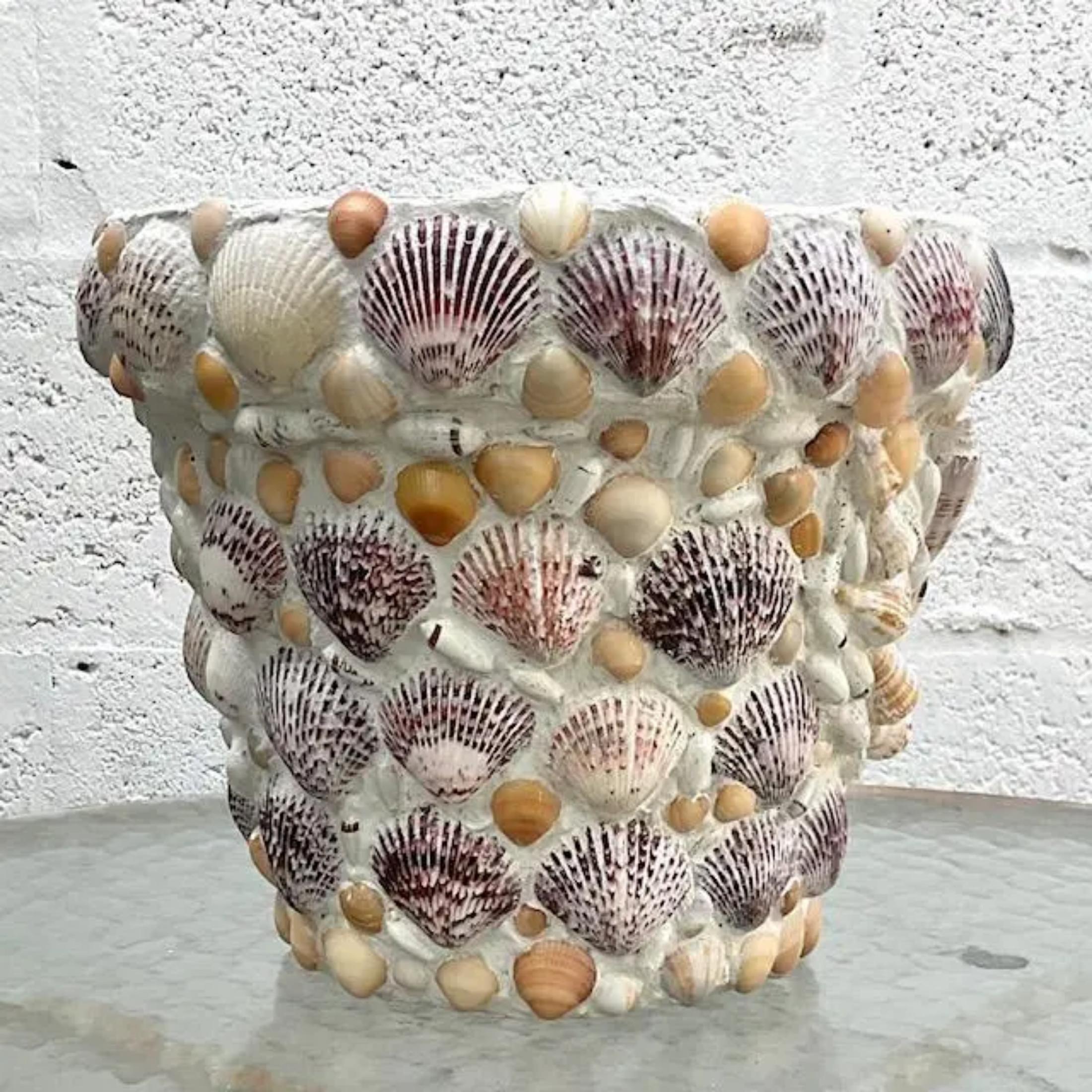 A fabulous vintage Coastal flower pot. A chic Italian terra Cotta pot that has been hand encrusted with shells. Sealed with concrete and a concrete sealer applied. Two pots available on my Chairish page. Acquired from a Palm Beach estate