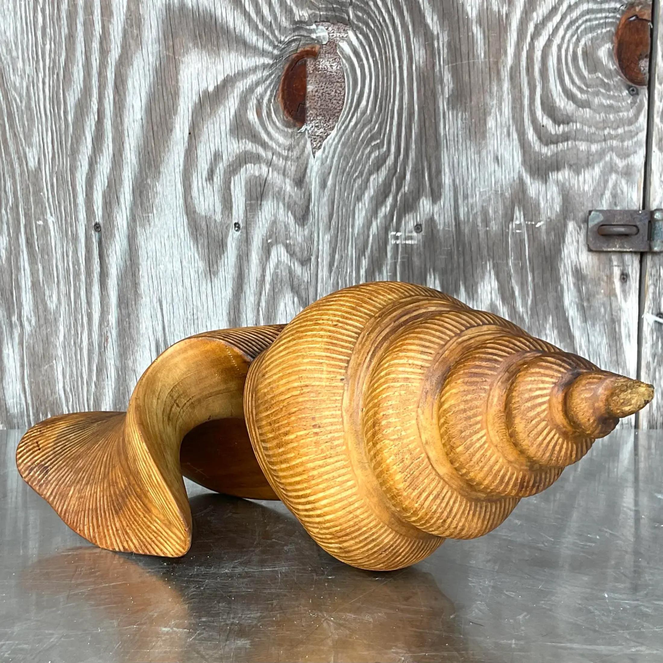 A stunning vintage Coastal wooden shell. A chic hand carved piece with gorgeous wood grain detail. Signed by the artist. Acquired from a Palm Beach estate. 