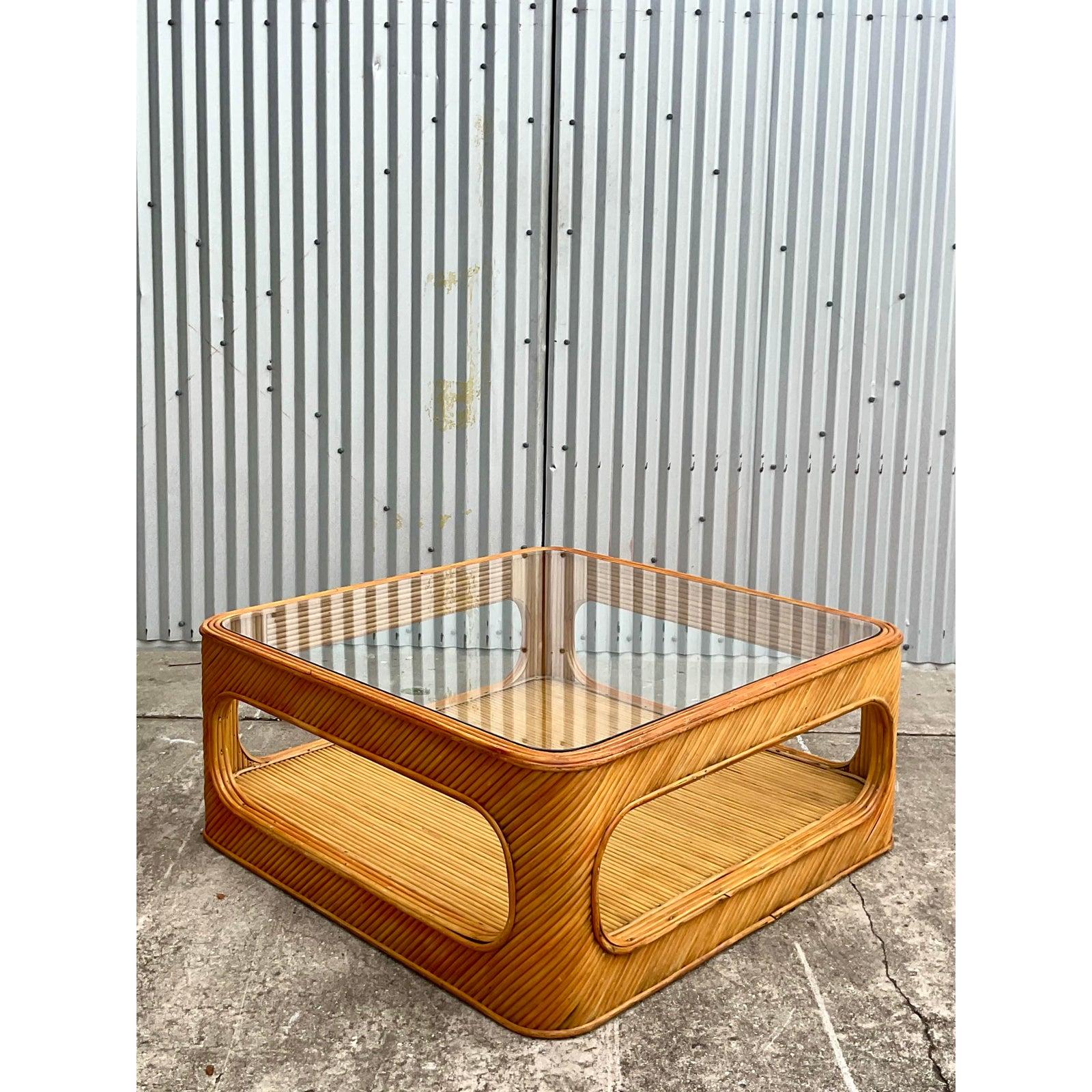 Fantastic vintage split bamboo coffee table. Chic cutout design and inset glass top. Acquired from a Palm Beach estate.