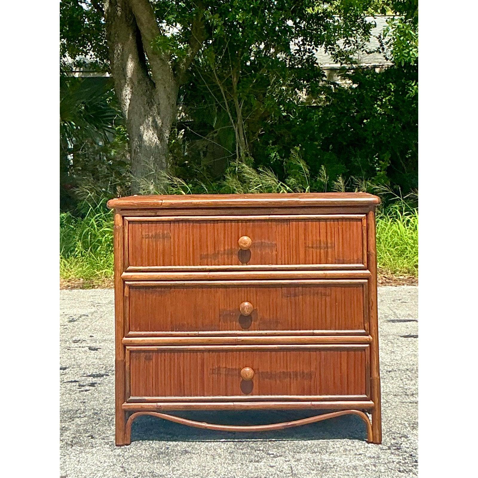 Embrace the relaxed sophistication of coastal design with this stunning vintage split reed chest of drawers. This piece showcases exceptional craftsmanship, featuring three spacious drawers meticulously wrapped in split reed, creating a rich, linear