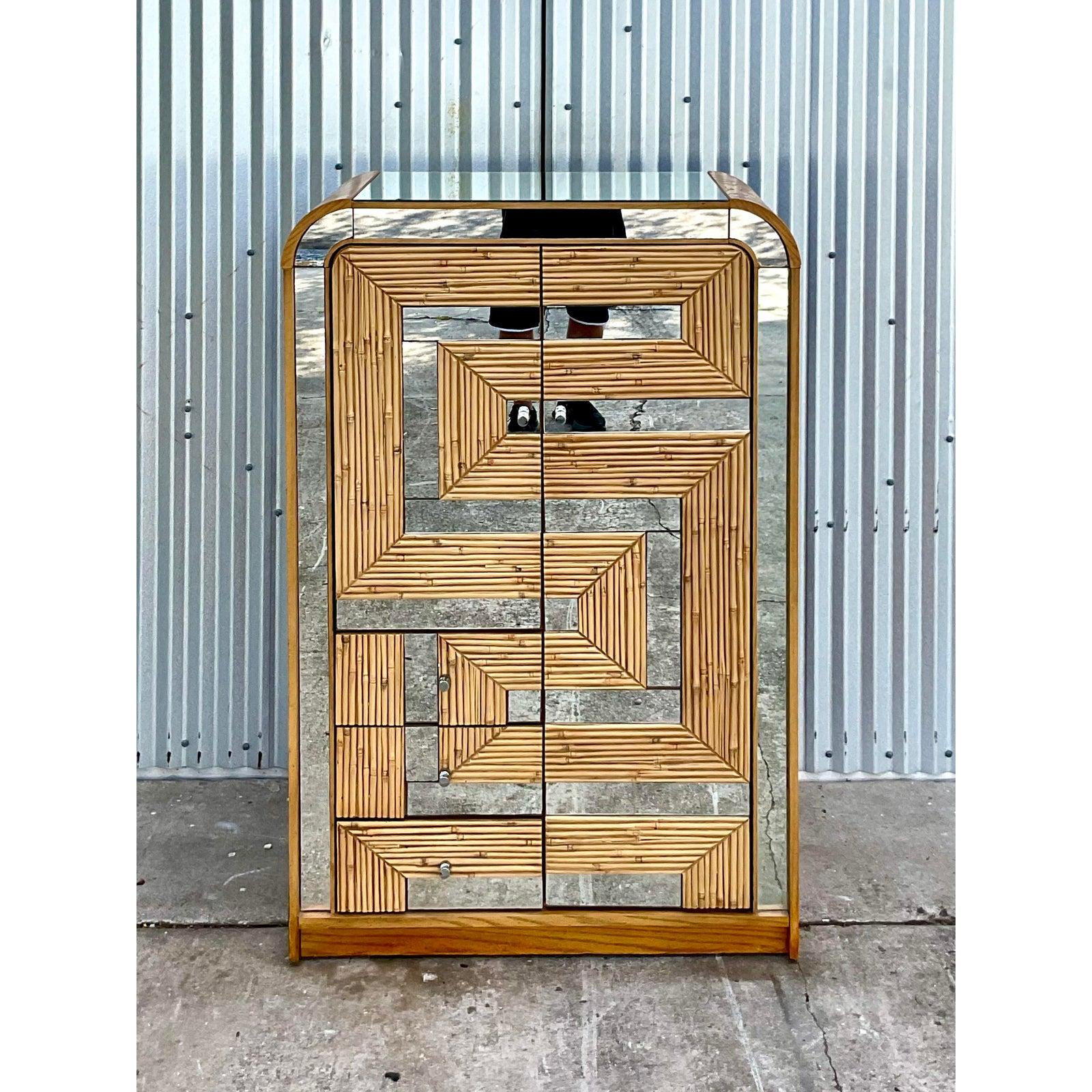 Fantastic vintage Coastal armoire. Beautiful split reed panels with a fab mirrored maze front. Lots of drawers and cabinets for storage. Acquired from a Palm Beach estate.