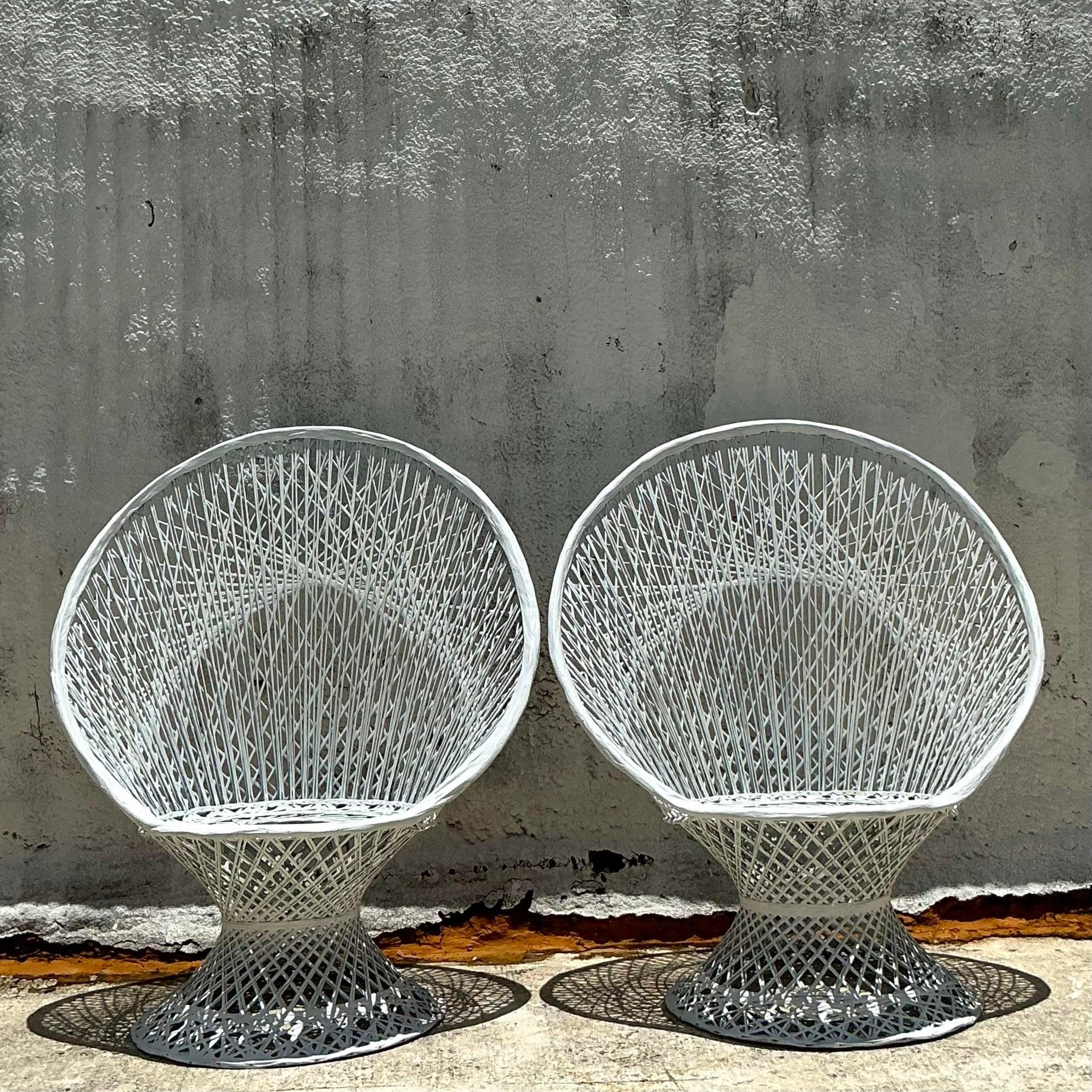 The Vintage Coastal Spun Fiberglass Peacock Chairs, inspired by Russell Woodard, blend coastal elegance with mid-century flair. These iconic chairs feature intricate spun fiberglass designs, offering a stylish and airy addition to any indoor or